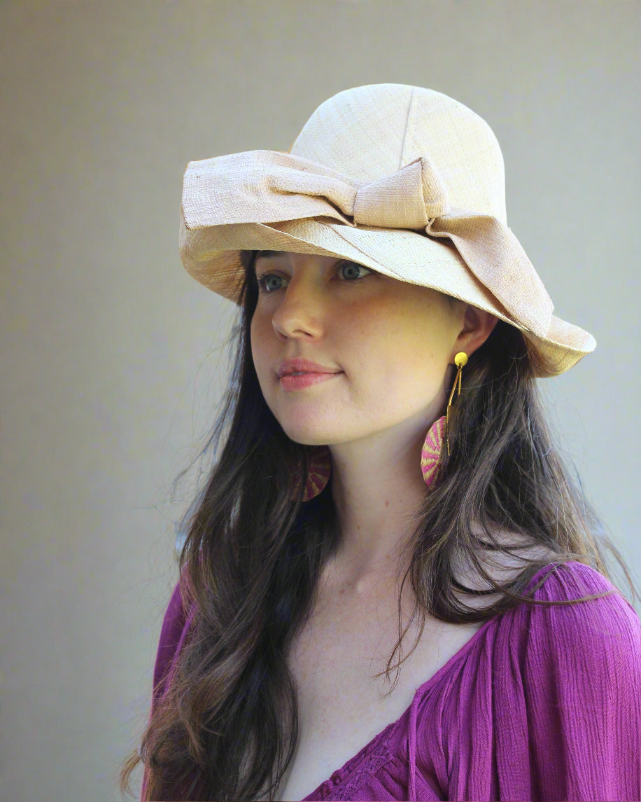 Model wearing Cara Big Bow Straw Hat Handmade loomed raffia straw hat solid natural bucket hat with large cappuccino tea/light/brown bow - Shebobo