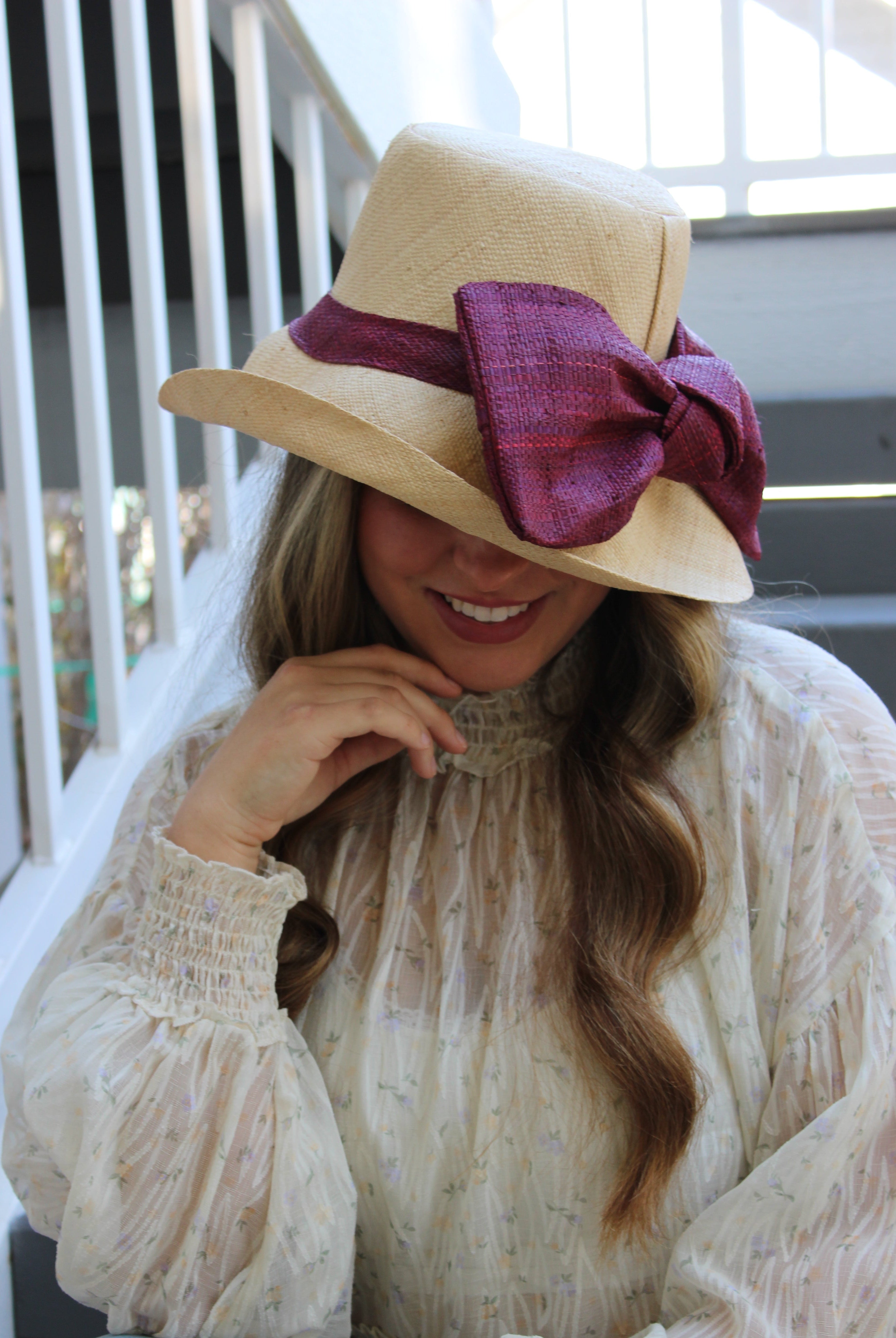 Model wearing Cara Big Bow Straw Hat Handmade loomed raffia straw hat solid natural bucket hat with large umberwine bordeaux/claret/deep/dark/red/purple bow - Shebobo