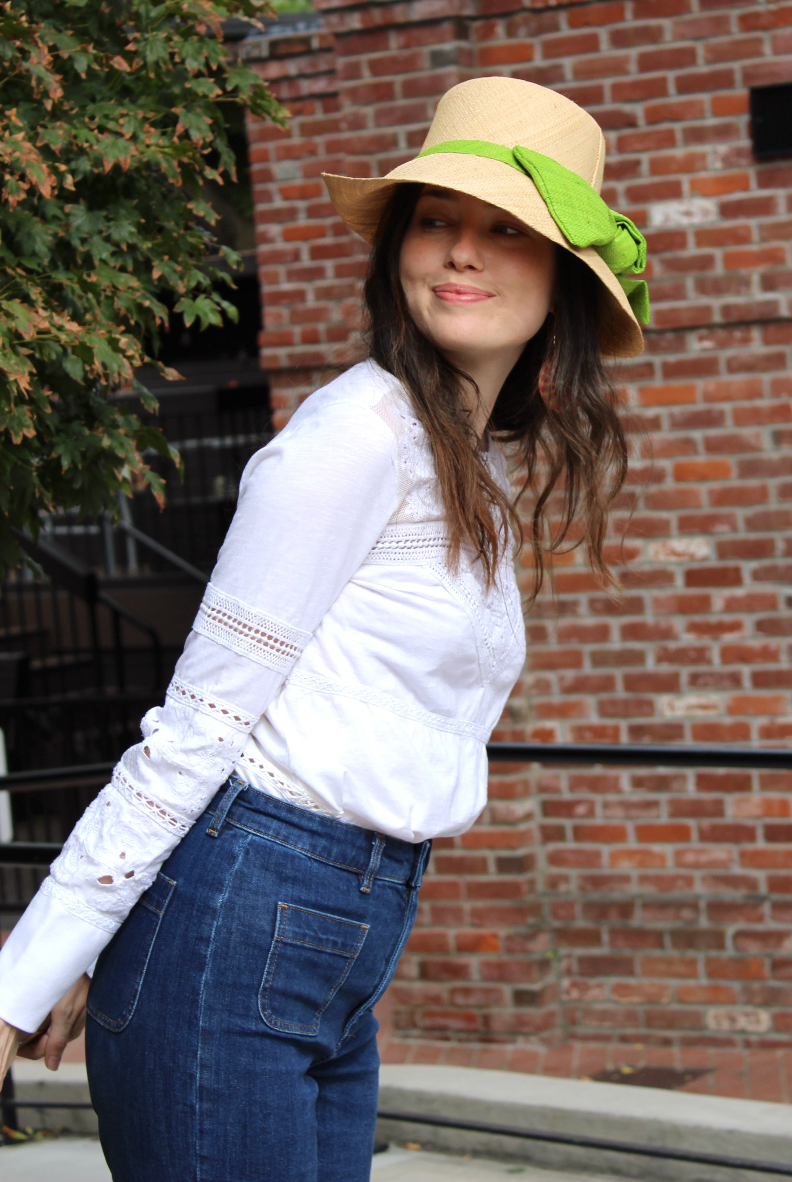 Model wearing Cara Big Bow Straw Hat Handmade loomed raffia straw hat solid natural bucket hat with large midori lime/bright/neon/green bow - Shebobo
