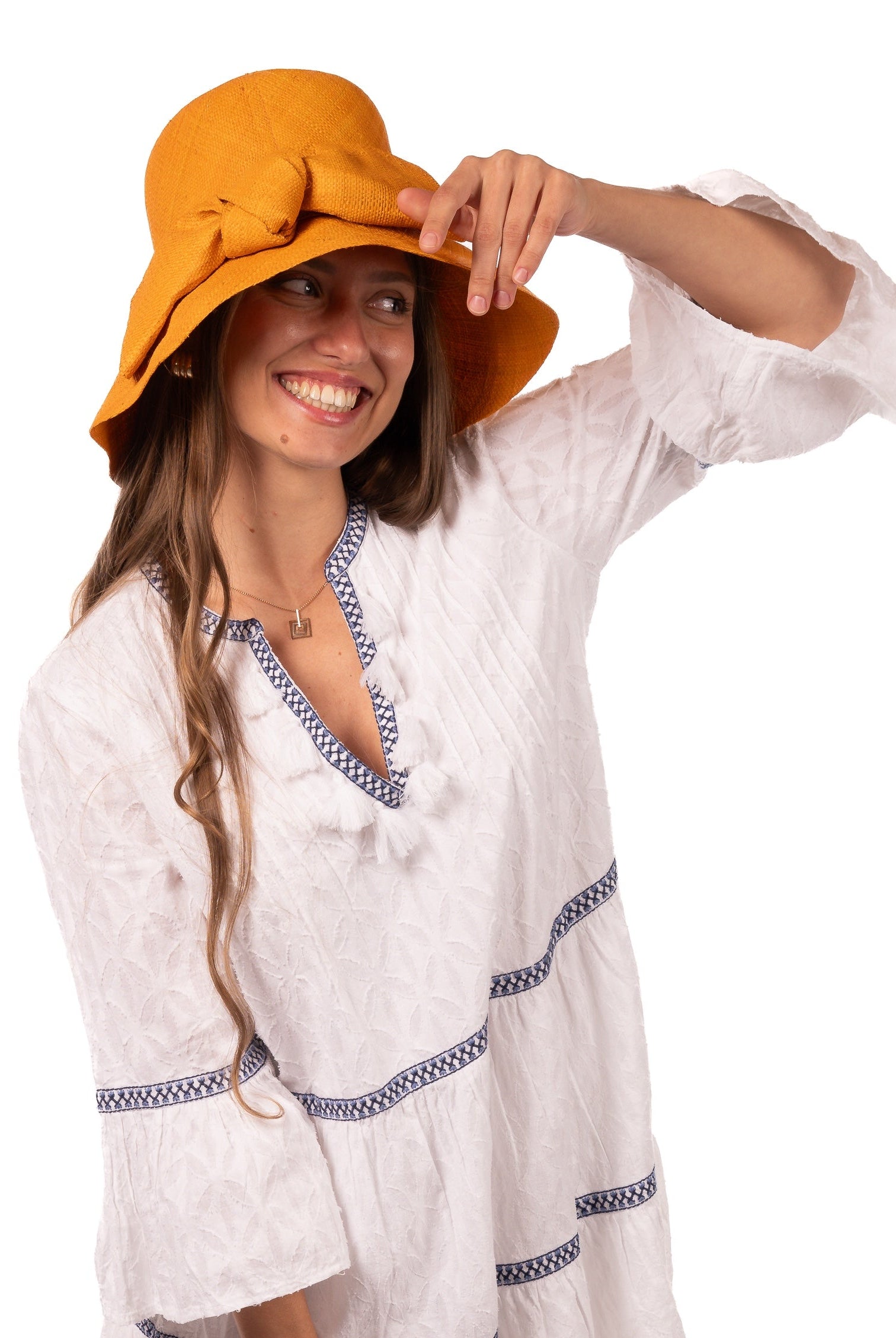 Model wearing Cara Saffron big bow embellishment handmade loomed raffia in a solid hue of saffron yellow/orange straw bucket style cloche sun hat with matching oversized bow - Shebobo