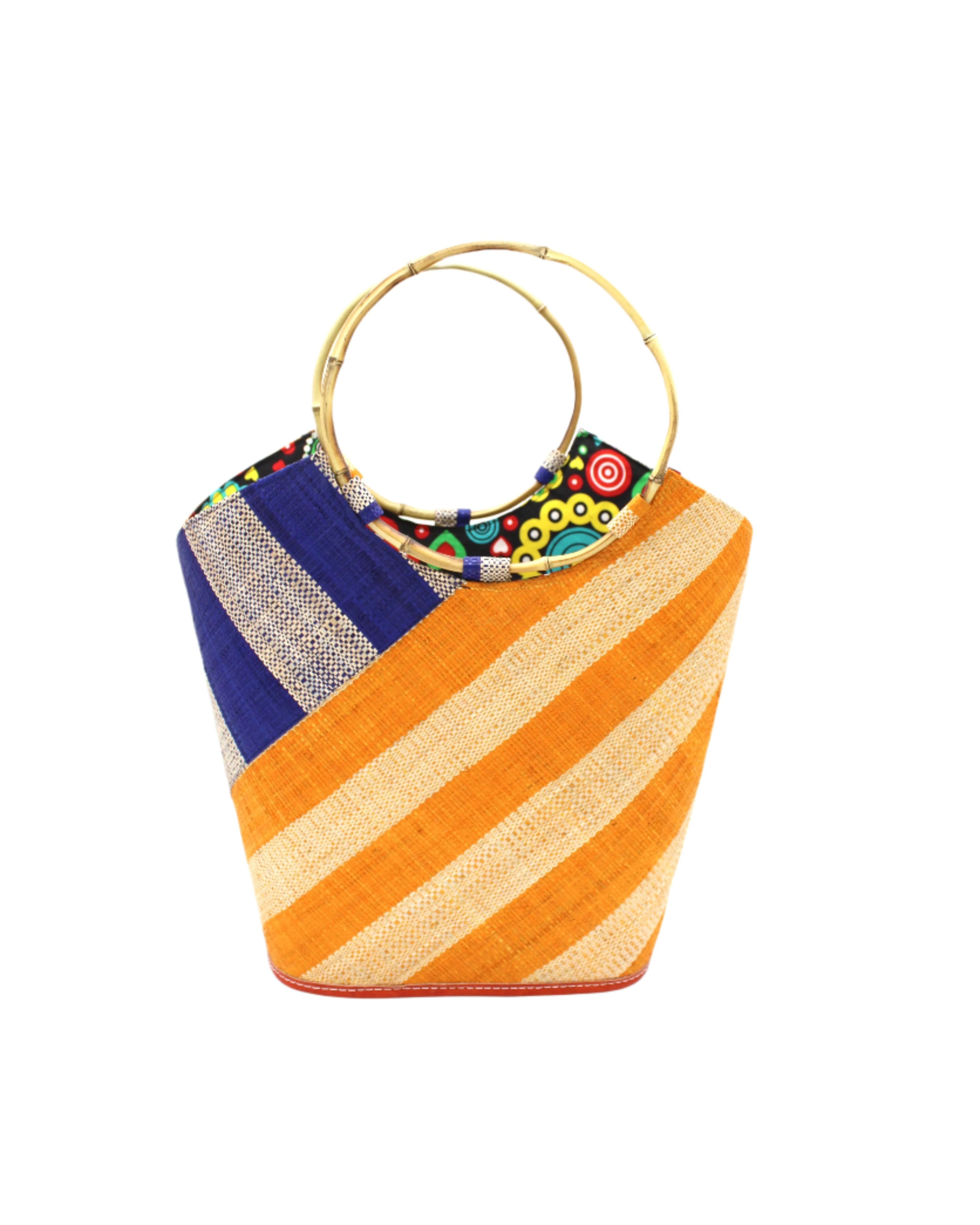 Carmen Double Wide Stripe Saffron & Dusk Straw Bucket Bag w/ Bamboo Handle handmade loomed raffia palm fiber in even width wide stripe pattern of Saffron yellow/orange and natural straw color oriented on the diagonal of three quarters of the bag with matching stripe pattern of dusk navy/dark/blue and natural diagonally on the top left corner quarter shoulder bag handbag - Shebobo