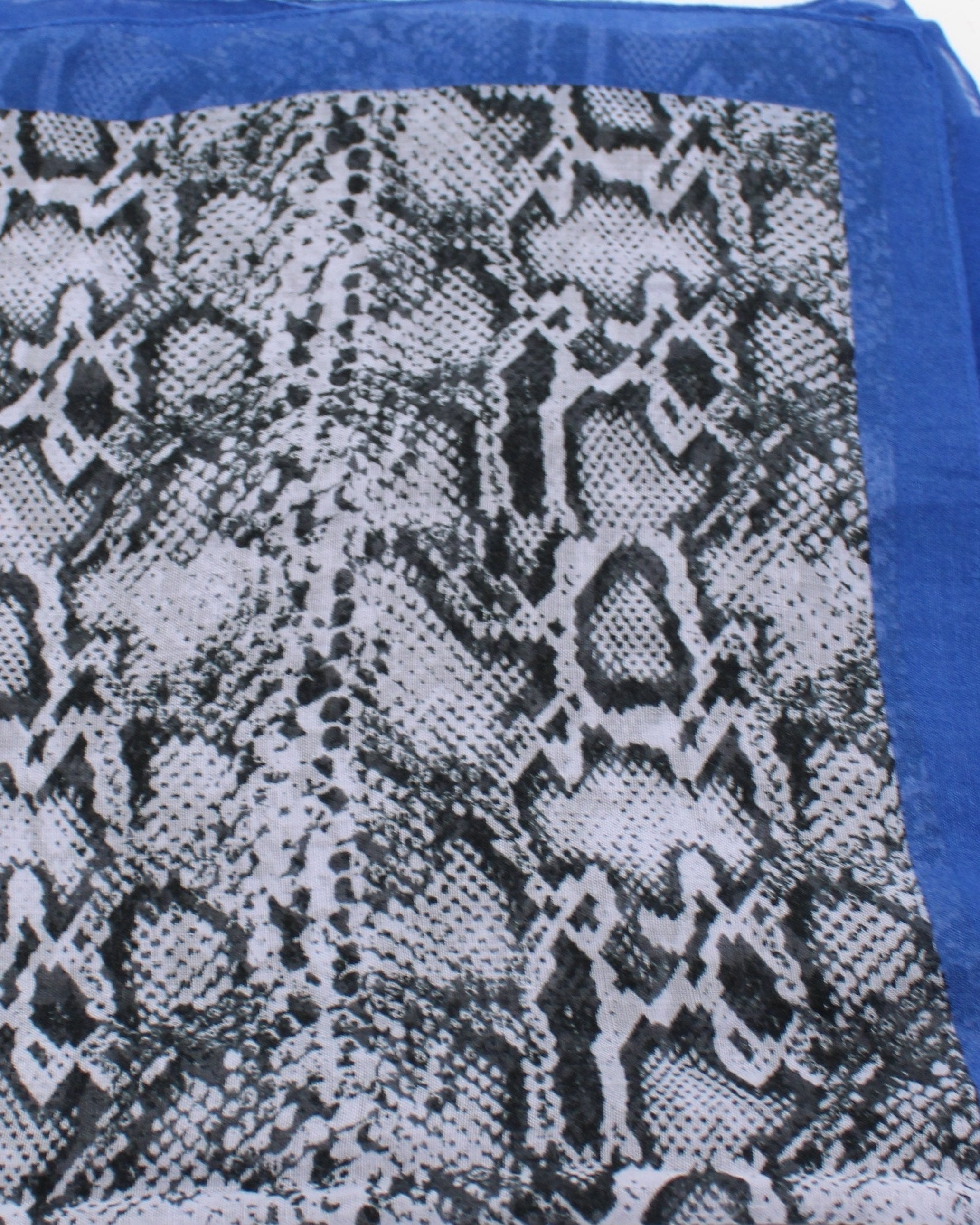 Detail view of pattern Cleo Snake Print Scarf Wrap Dusk Blue, Black, and White Multicolor Snake Skin Patterned Scarf with colored edge - Shebobo