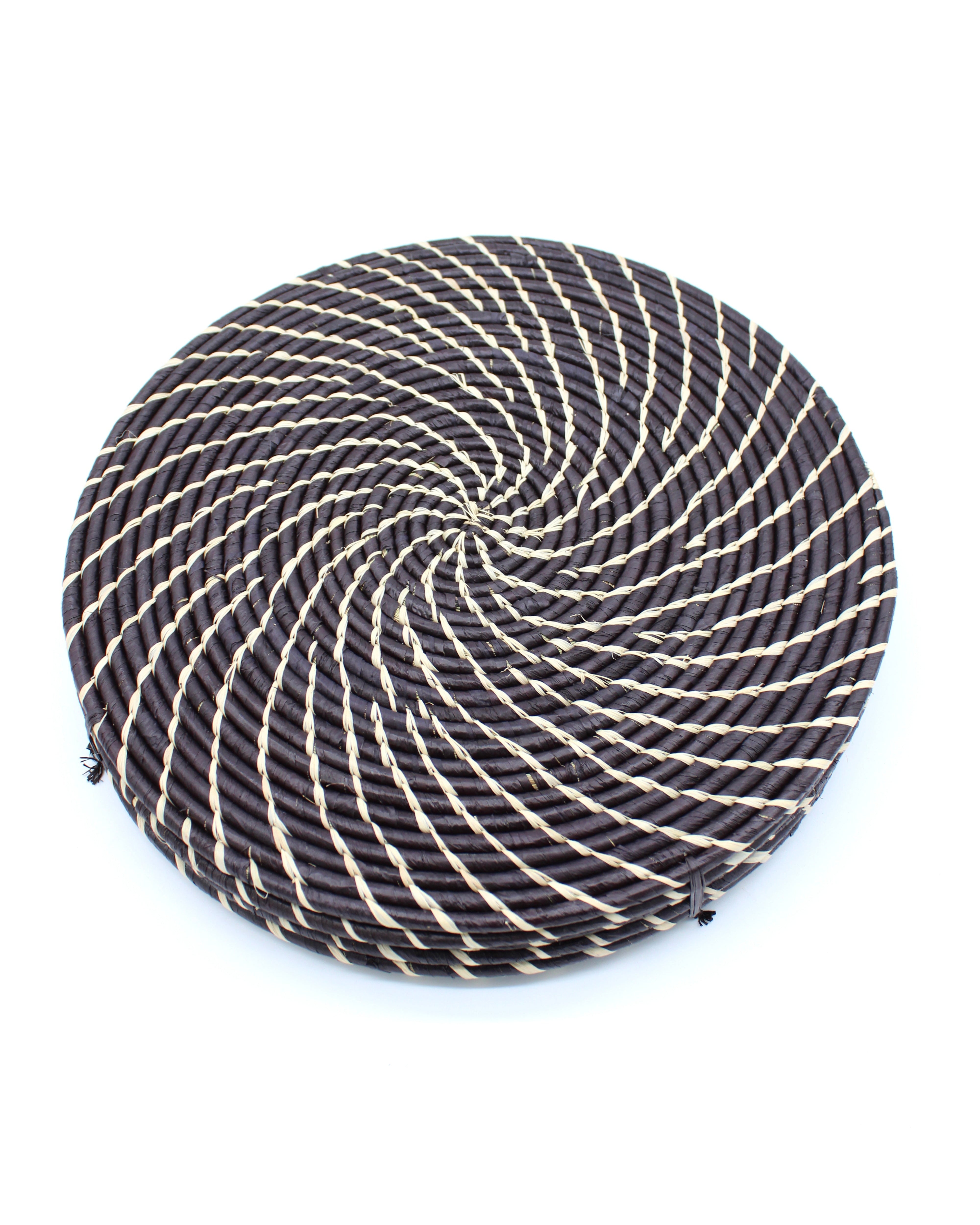 Dabu Round Two Tone Swirl Raffia Straw Coasters & Placemats Set of 6 handmade natural raffia palm fiber in a crochet loop disc technique creating concentric circular stripe pattern of texture in a solid hue of black with contrasting knotted spiral swirl weave in natural straw color sets of six placemats or coasters - Shebobo