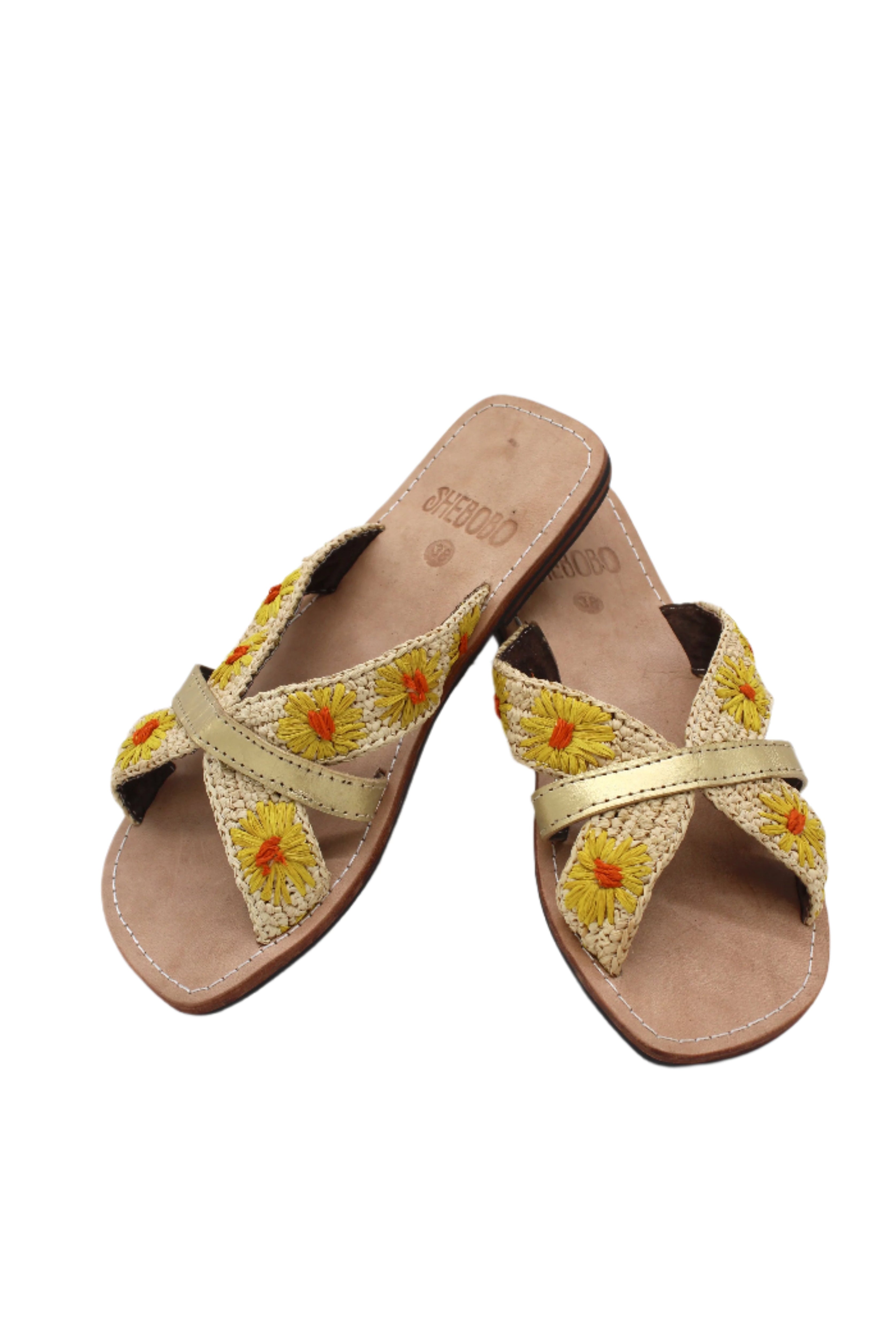 Daisy Crochet Straw & Leather Sandal with Flower Embroidery & Metallic Detailing handmade crochet natural raffia palm fiber in a solid hue of natural straw color in two bands with saffron yellow petals and coral orange/red centered embroidered flower pattern wrap around the top of the shoe with a band of metallic gold across the top summer sandals shoes - Shebobo