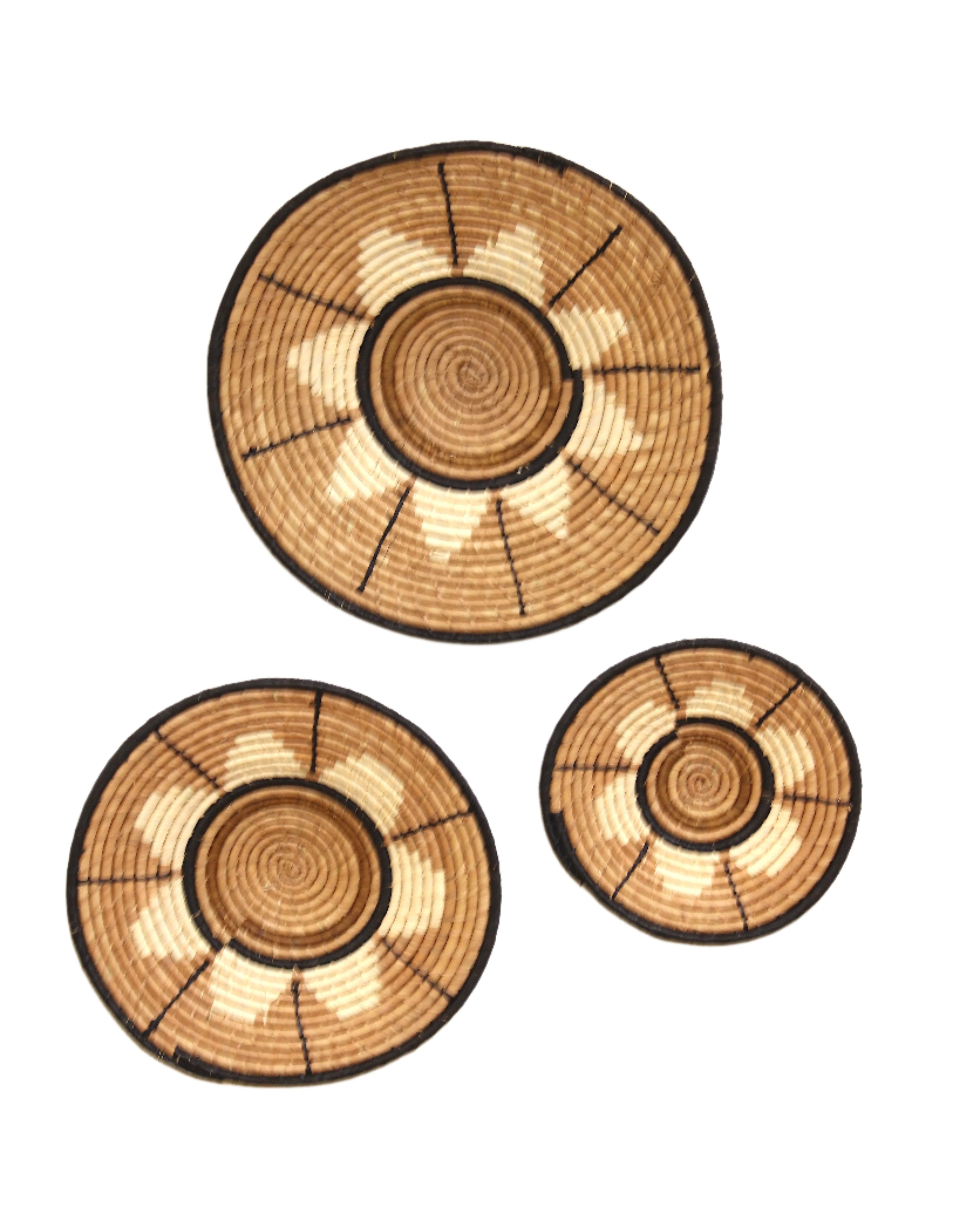 Dakarai Raffia Straw Wall Decor Display Basket Tray: Set of 3 handmade woven natural raffia palm fiber in a crochet loop technique concentric coiled circular pattern with natural straw color, cappuccino/tea/light/brown, cinnamon/tobacco/dark/brown, and black centered star flower pattern set of three sized flat bowl trays - Shebobo