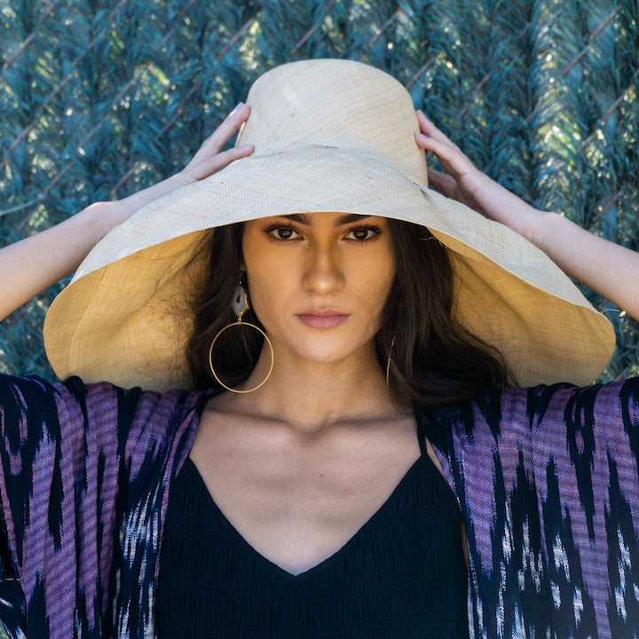 Model wearing Estrella 7 inch wide floppy brim handmade loomed raffia palm fiber natural straw color packable lightweight straw hat - Shebobo