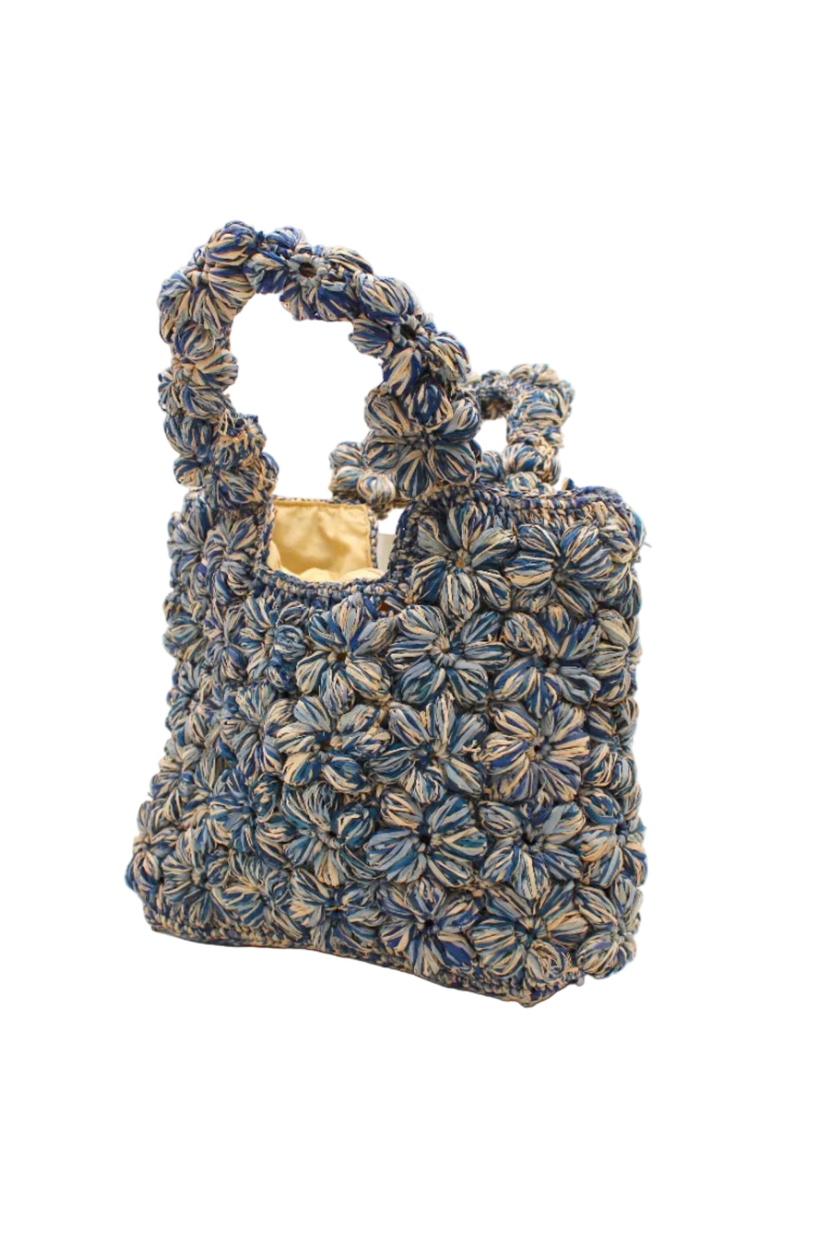 Side view Florence Denim Blues Multicolor Flower Crochet Straw Basket Handbag handmade natural raffia palm fiber in a multicolor hue combination of natural straw color, denim light/retro/blue, and luminous navy/dark/blue with subtle tied flower design consisting of 88 flowers crochet together along the outside of the bag as well as the handles purse tote - Shebobo