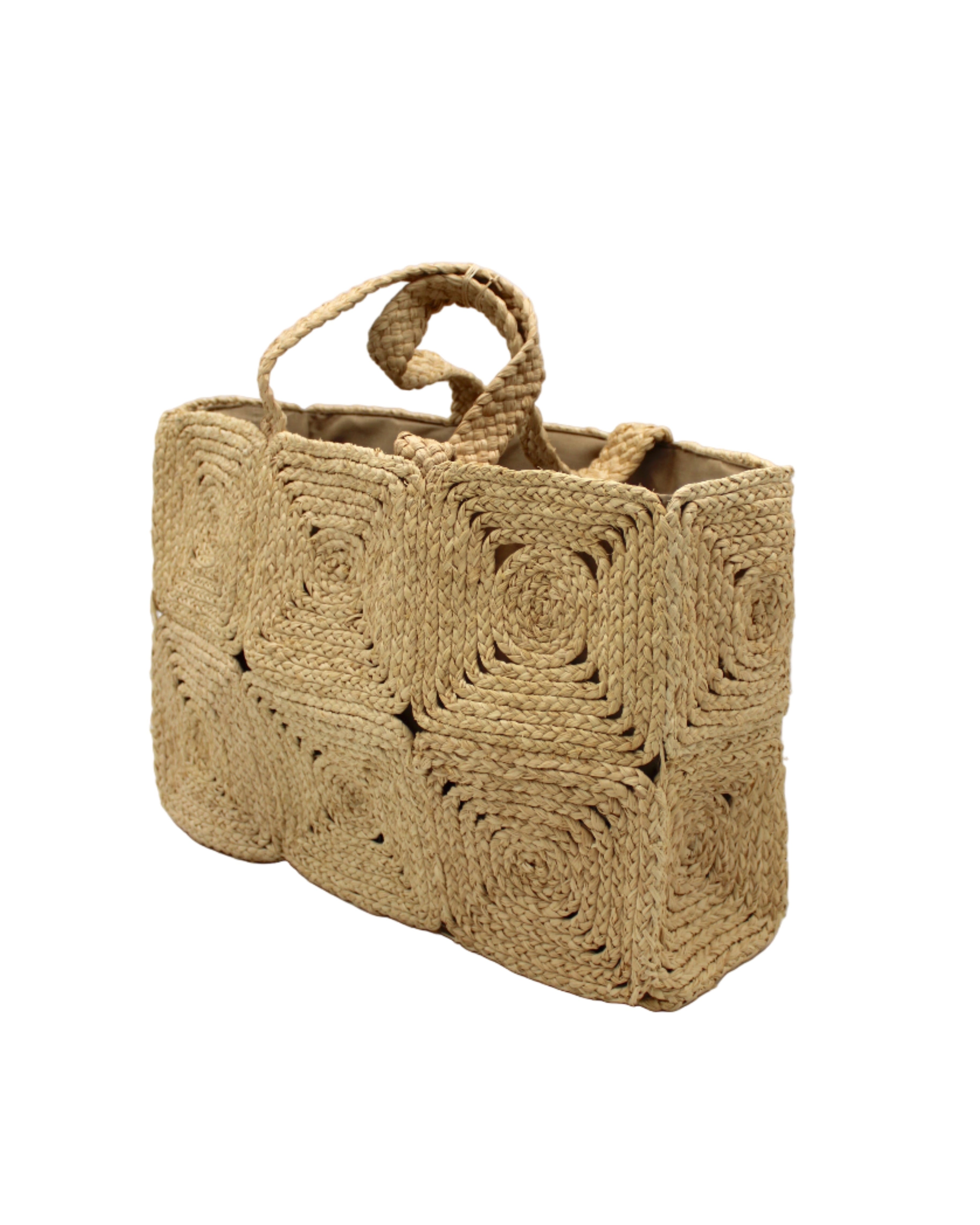 Side view Gemma Crochet Disc Rectangle Large Straw Basket Handbag handmade braided natural raffia palm fiber in a solid hue of Natural straw color with subtle square disc pattern around the outside of the bag in two horizontal bands of squares creating a geometric pattern and matching woven handles beach bag purse - Shebobo