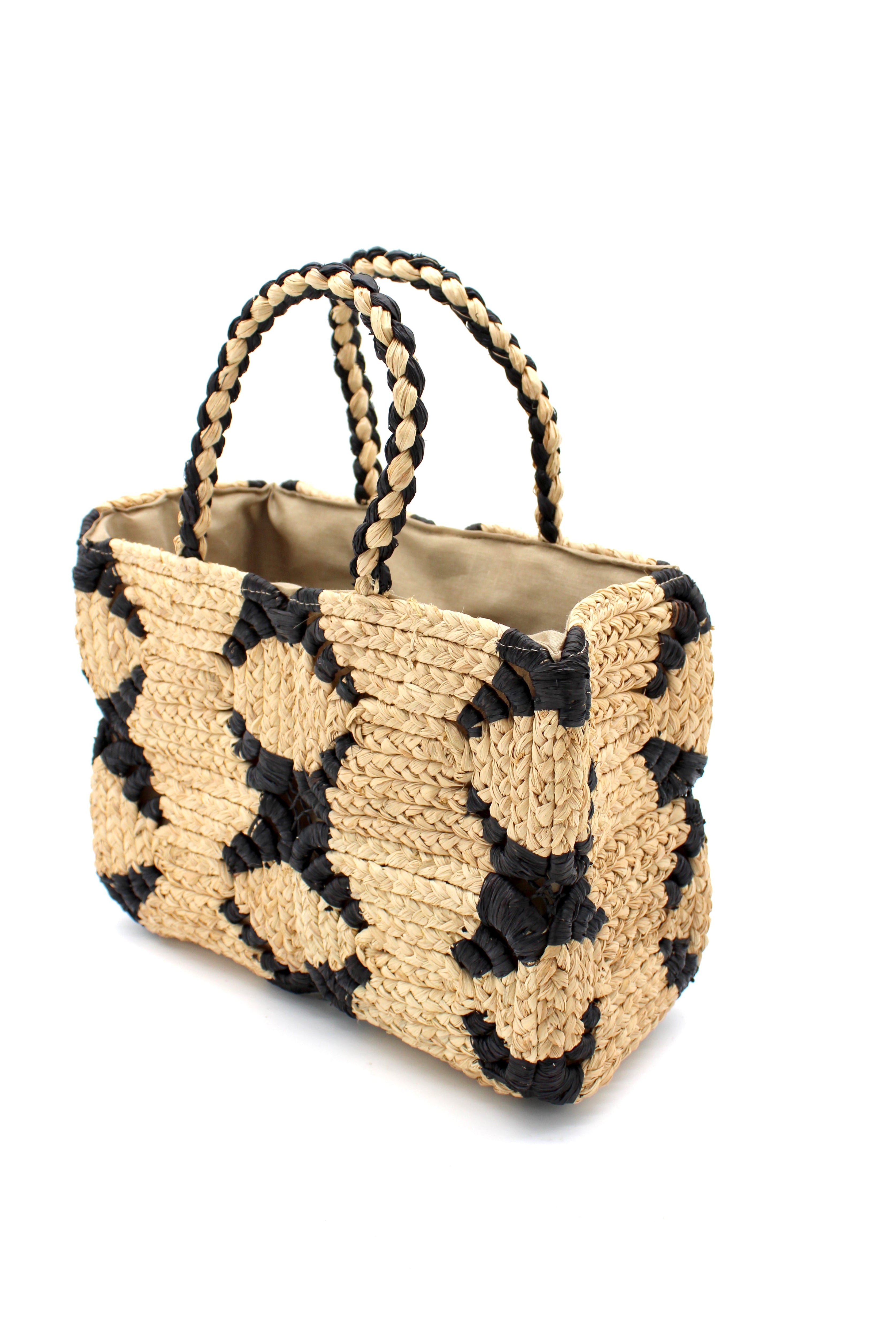 Side View Gemma Crochet Disc Rectangle Black and Natural Straw Basket Handbag handmade woven raffia palm fiber in a two tone multicolor pattern of black and natural straw color create a coiled braid disc pattern result in a star pattern around the bag with matching woven handles top handle bag - Shebobo