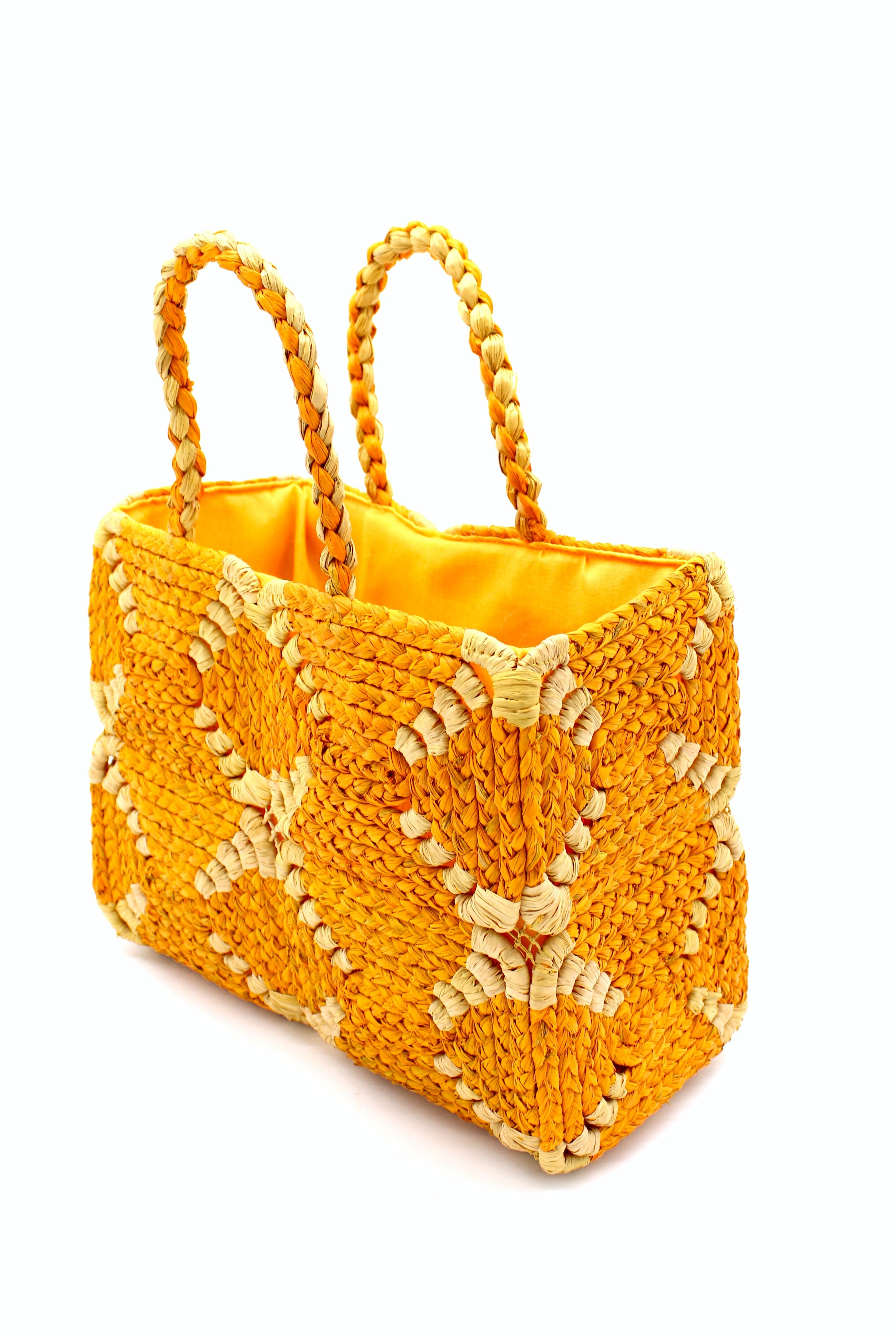 Side view Gemma Crochet Disc Rectangle Saffron and Butter Straw Basket Handbag handmade woven raffia palm fiber in a two tone multicolor pattern of saffron yellow/orange and butter light yellow create a coiled braid disc pattern result in a star pattern around the bag with matching woven handles top handle bag - Shebobo