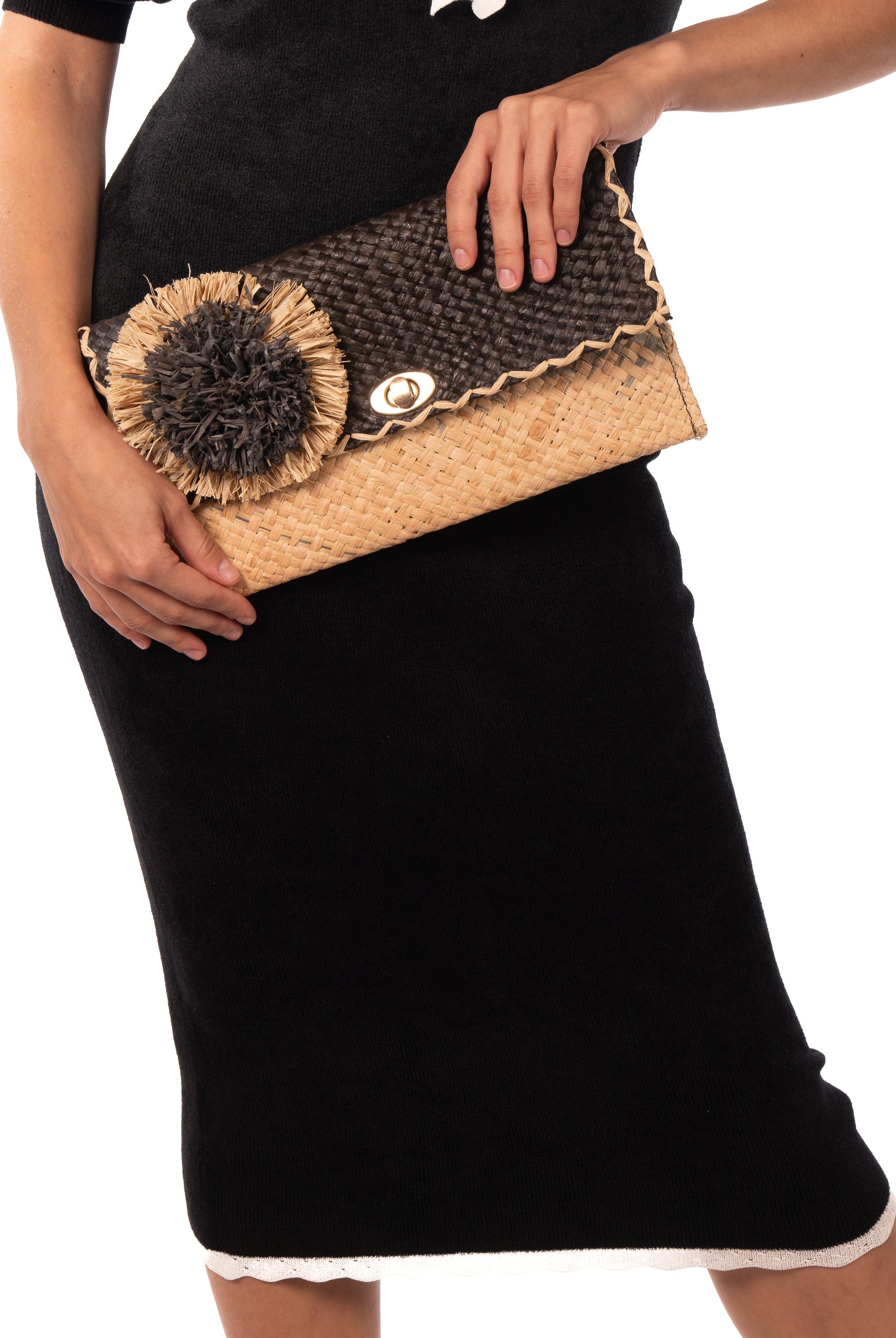 Model wearing Holden Ombre Black Straw Clutch with Flower Pouf handmade woven raffia dip dyed gradient of black, grey, and natural with large two tone natural and grey fringe flower embellishment - Shebobo