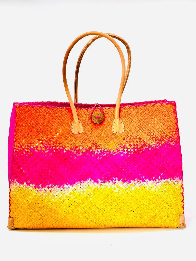 Holden Fuchsia Ombre Zafran Large Straw Beach Bags handmade dip dyed raffia woven into a three part horizontal ombre pattern of coral orange/red on the top, fuchsia pink in the middle and both sides, and saffron yellow on the bottom with cross stitch edging, wooden button, and leather handles - Shebobo