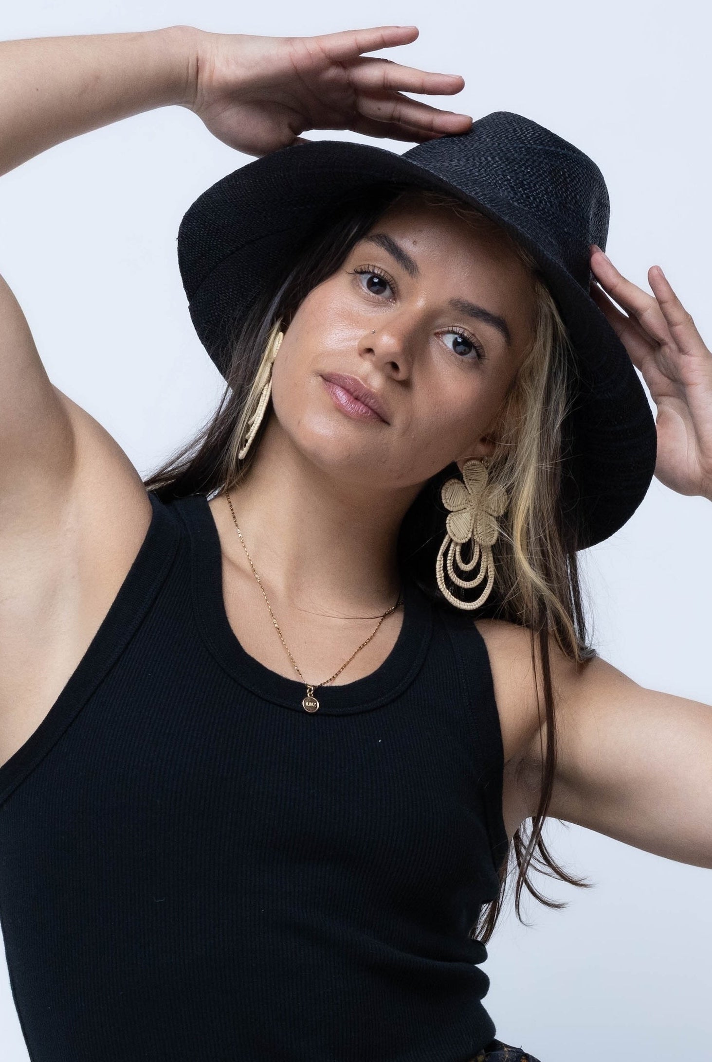 Model wearing Panama black unisex straw hat handmade 3" brim loomed raffia black travel hat sun hat - Shebobo