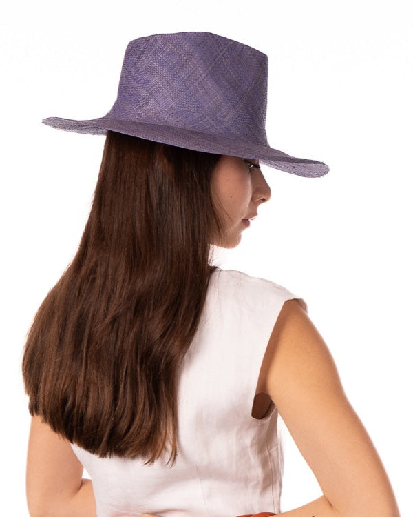 Model wearing Jamie Panama 3" brim handmade loomed raffia in a solid hue of denim retro/light/blue with attached matching hat band uv/sun protection lightweight breathable straw sun hat - Shebobo