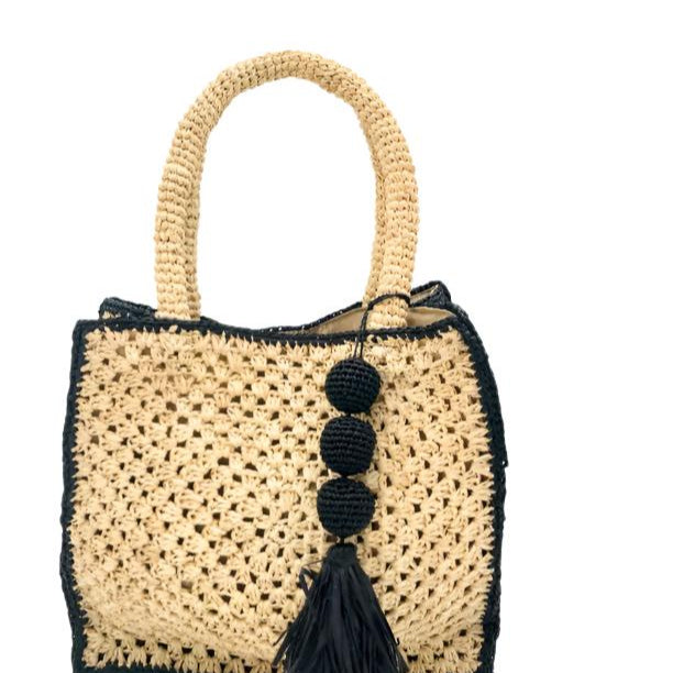 Kimba handmade crochet two tone handbag purse natural straw color with black trim and crochet cascading balls plus tassel bag charm embellishment - Shebobo