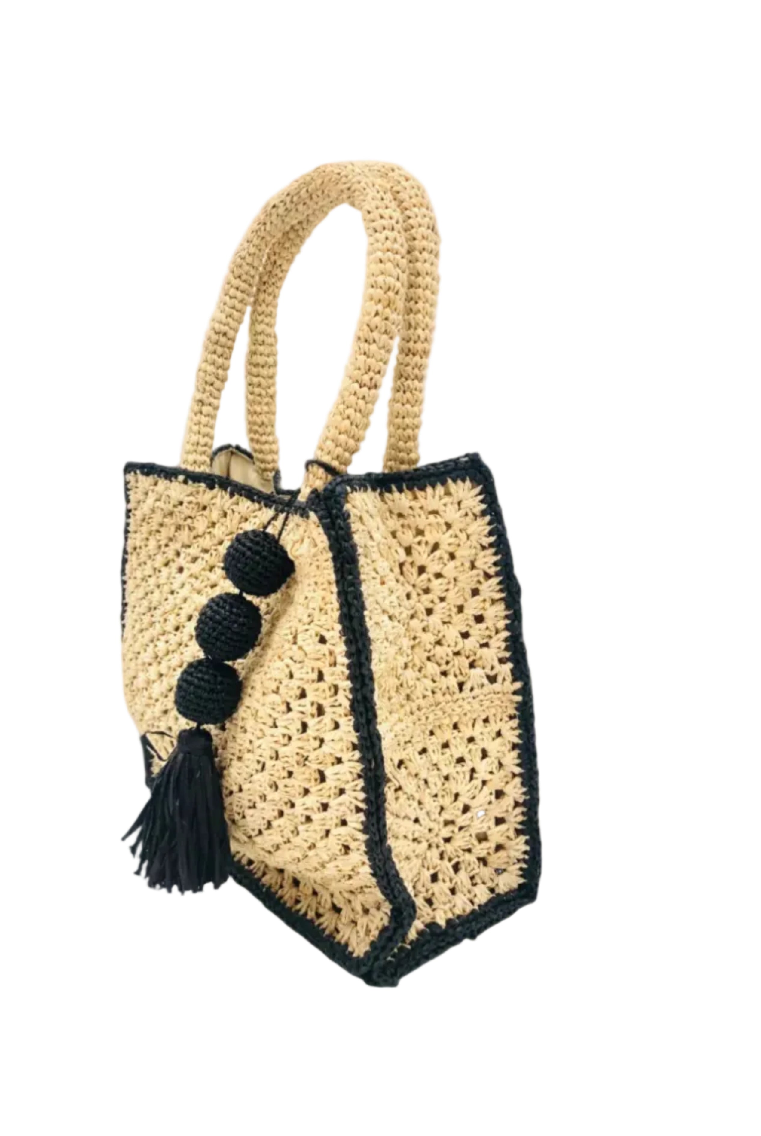 Side view Kimba handmade crochet two tone handbag purse natural straw color with black trim and crochet cascading balls plus tassel bag charm embellishment - Shebobo