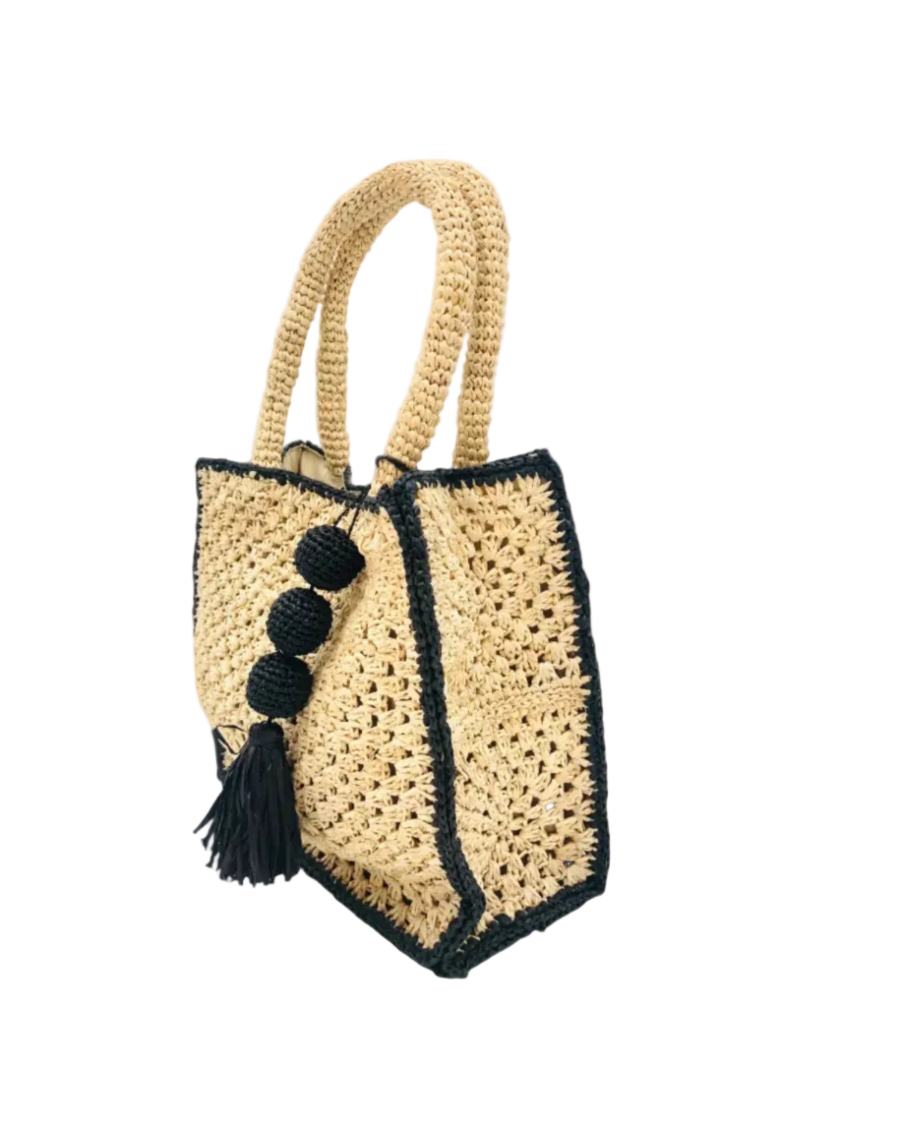 Side view Kimba handmade crochet two tone handbag purse natural straw color with black trim and crochet cascading balls plus tassel bag charm embellishment - Shebobo