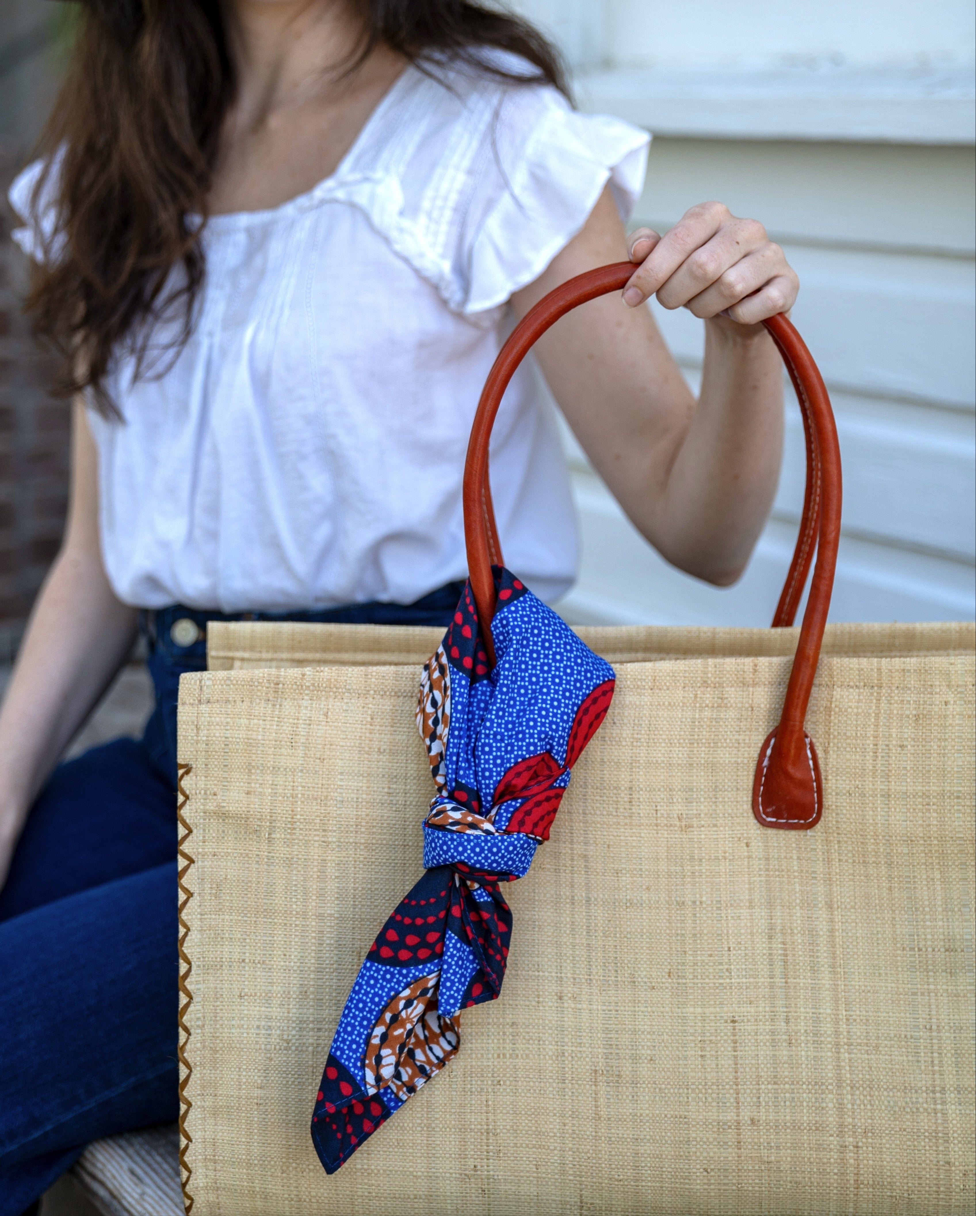 Model wearing bag embellishment Kamari African Print Wax Cloth Multicolor bright bold fun assorted print double layer bandanas can be worn as headbands or kerchief - Shebobo (Monica 5" & 7" Wide Brim Solid Color Packable Straw Sun Hats)