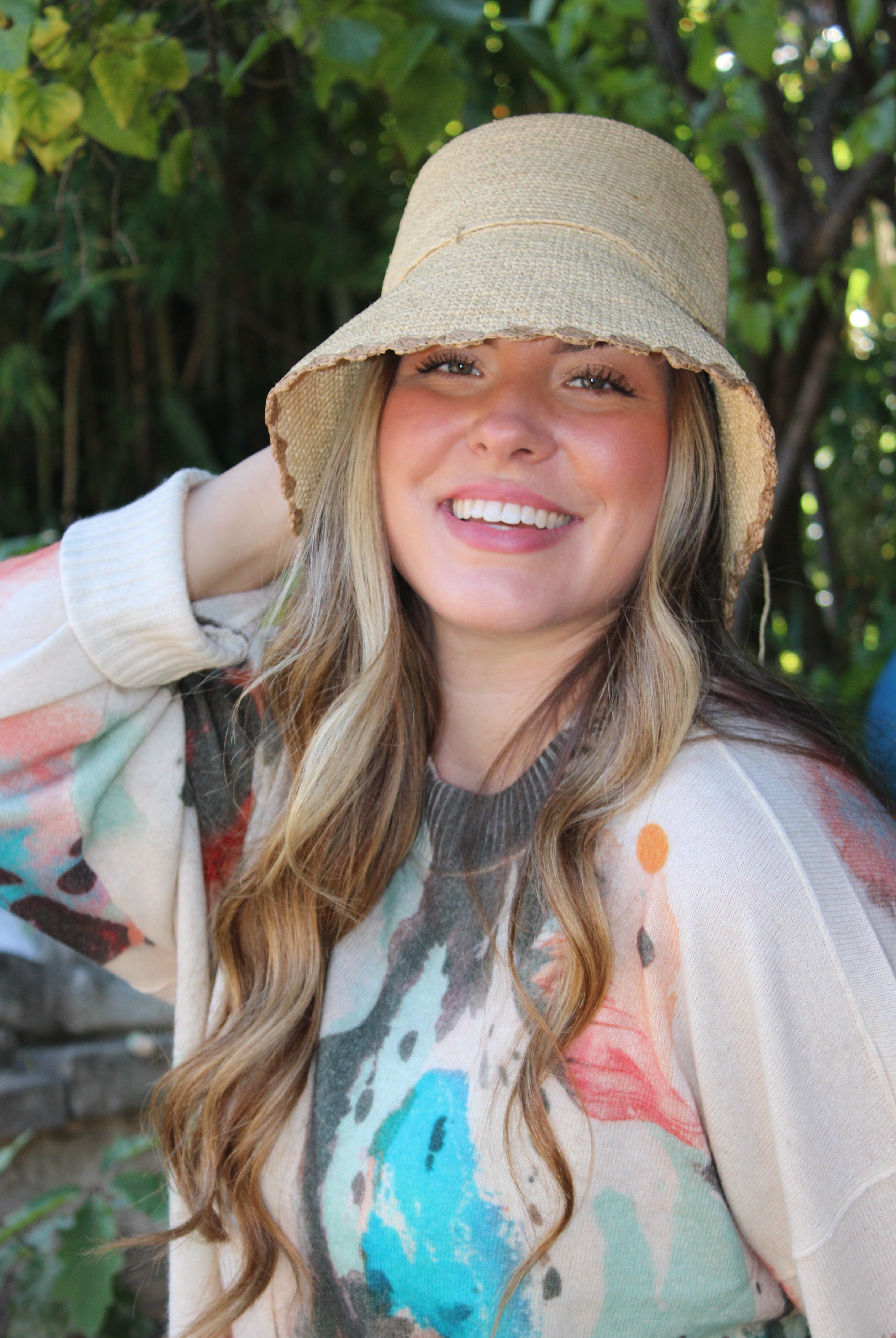 Model wearing Kate Natural with Cappuccino Crochet Bucket Straw Hats with Colored Lace Weave Edge handmade woven raffia palm fiber in a solid hue of natural straw color in a subtle link texture with cappuccino tea/light/brown lace weave floral edge trim around the outer brim two tone multicolor uv protection hat - Shebobo