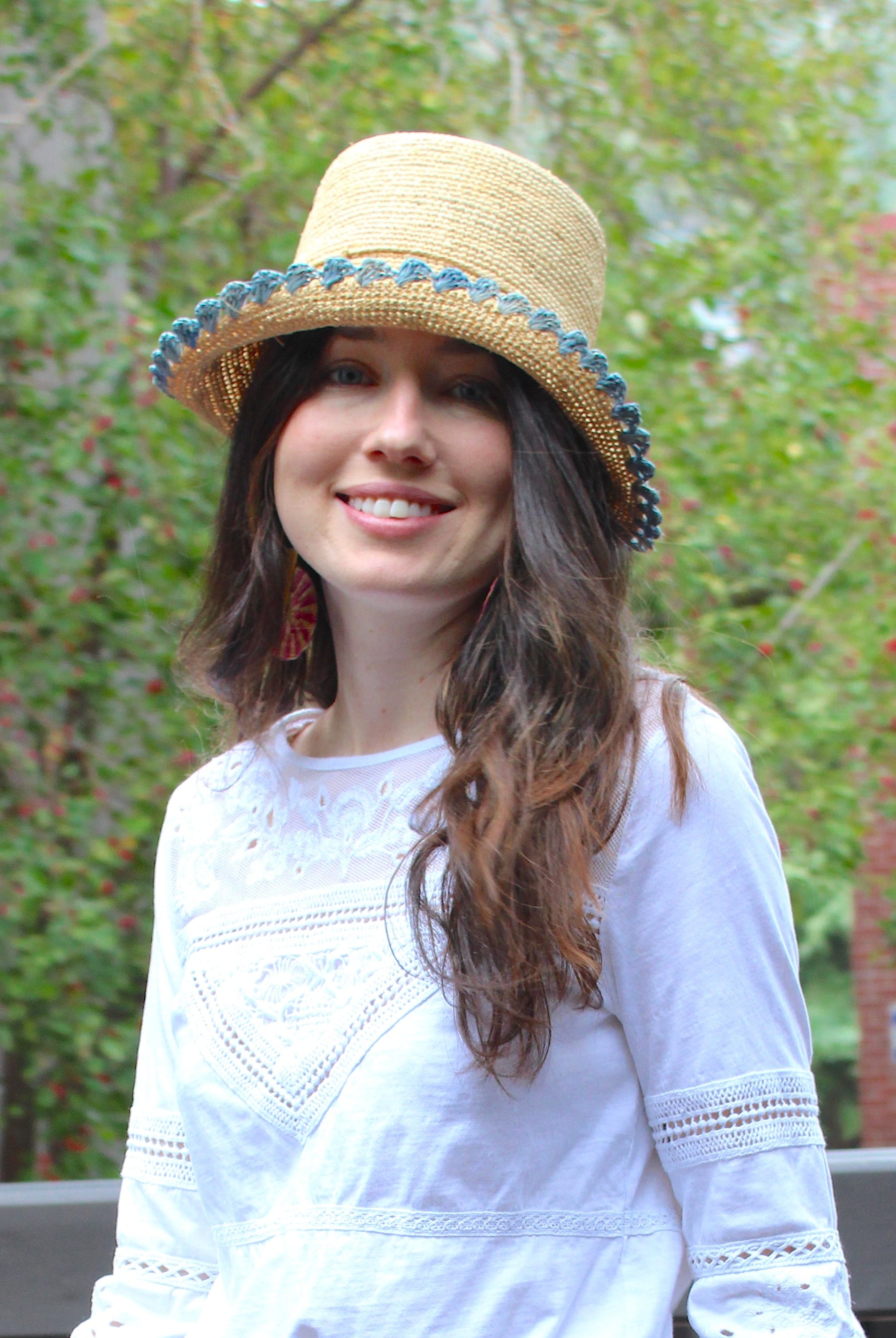 Model wearing Kate Natural with Denim Crochet Bucket Straw Hats with Colored Lace Weave Edge handmade woven raffia palm fiber in a solid hue of natural straw color in a subtle link texture with denim retro/light/blue lace weave floral edge trim around the outer brim two tone multicolor uv protection hat - Shebobo