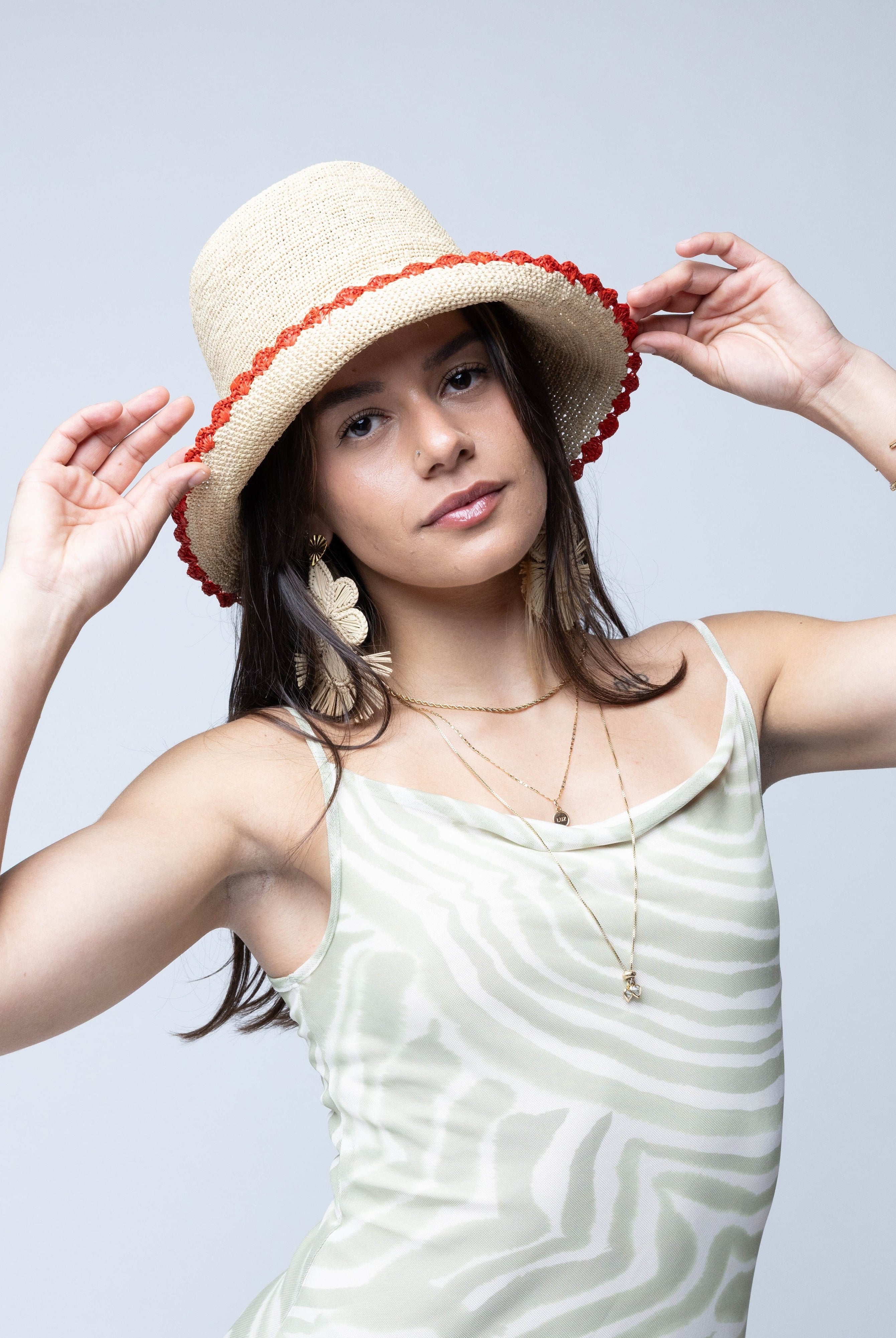 Model wearing Kate Natural with Fuchsia Crochet Bucket Straw Hats with Colored Lace Weave Edge handmade woven raffia palm fiber in a solid hue of natural straw color in a subtle link texture with coral orange/red lace weave floral edge trim around the outer brim two tone multicolor uv protection hat - Shebobo