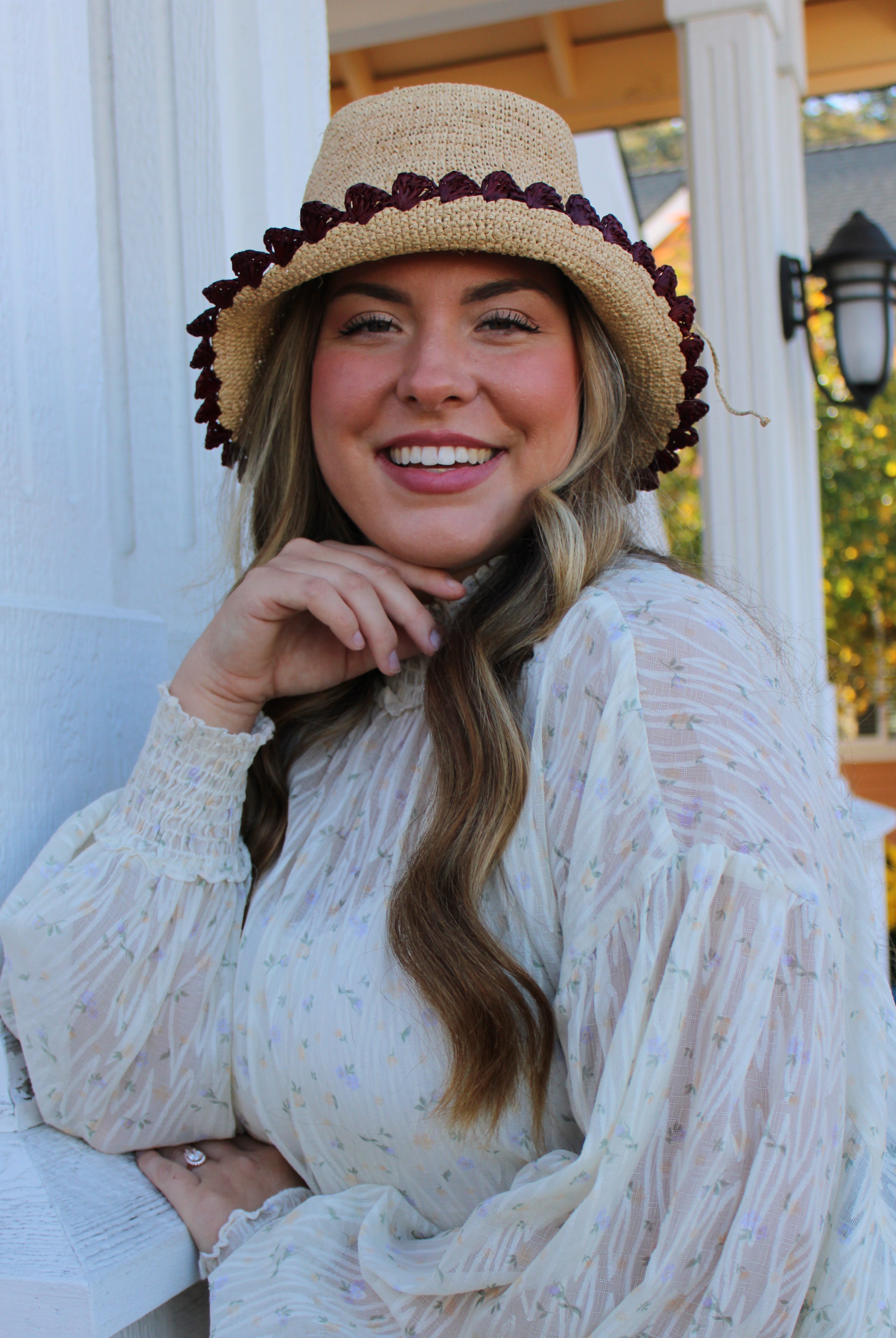 Model wearing Kate Natural with Umberwine Crochet Bucket Straw Hats with Colored Lace Weave Edge handmade woven raffia palm fiber in a solid hue of natural straw color in a subtle link texture with umberwine bordeaux/claret/deep/dark/red/purple lace weave floral edge trim around the outer brim two tone multicolor uv protection hat - Shebobo