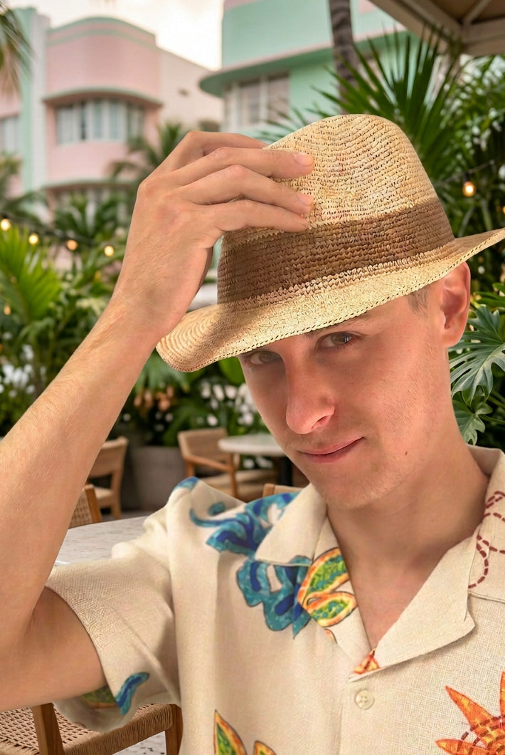 Model wearing Kelly Crochet Fedora - Unisex Straw Sun Hats handmade woven natural raffia palm fiber in a solid hue of natural straw color with woven in hatband of cinnamon/tobacco/brown - Shebobo