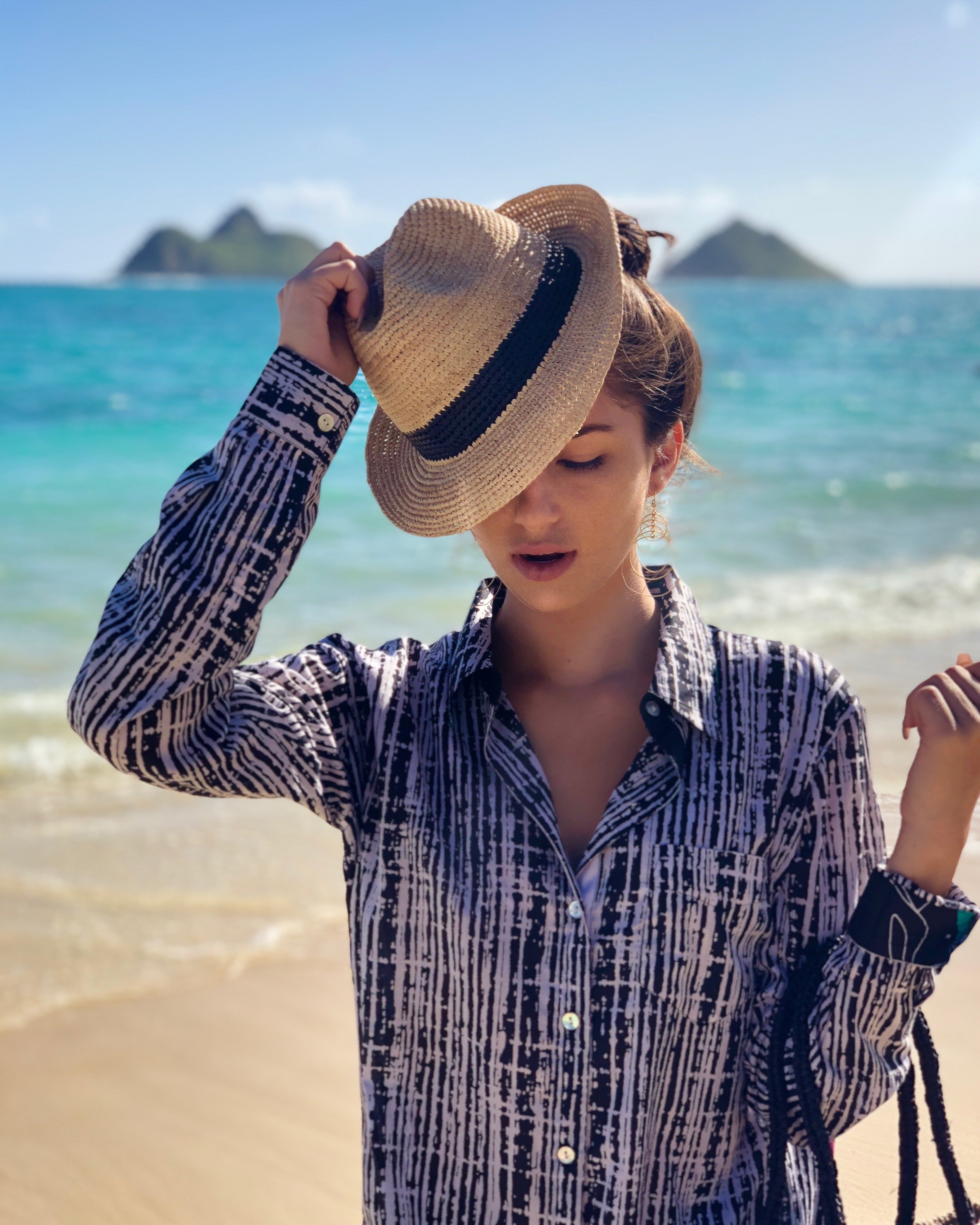 Model wearing Kelly Crochet Fedora - Unisex Straw Sun Hats handmade woven natural raffia palm fiber in a solid hue of natural straw color with woven in hatband of black - Shebobo