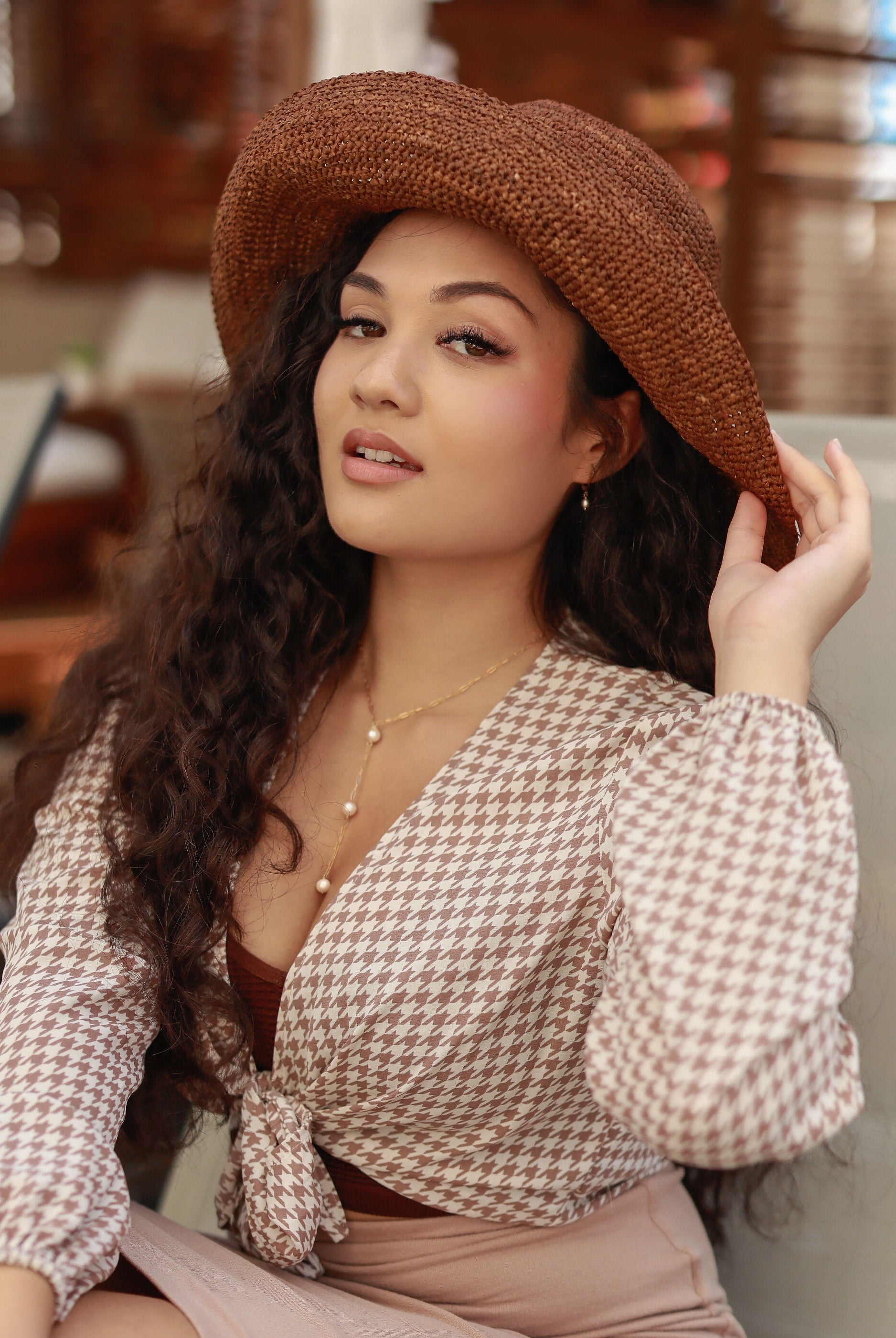 Model wearing 3" Brim Leor cinnamon/tobacco/brown handmade crochet packable straw hat with adjustable band - Shebobo