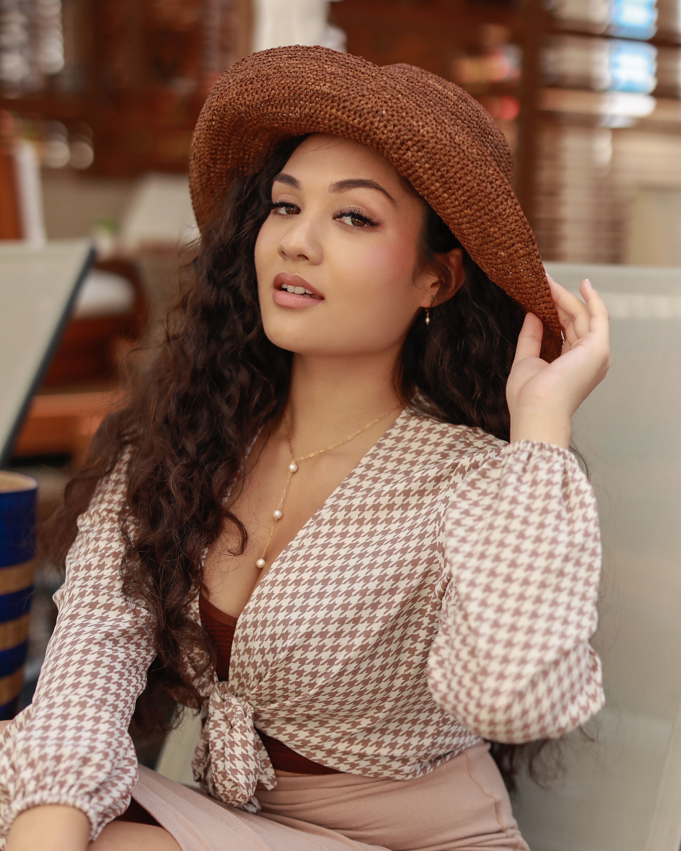 Model wearing 3" Brim Leor cinnamon/tobacco/brown handmade crochet packable straw hat with adjustable band - Shebobo