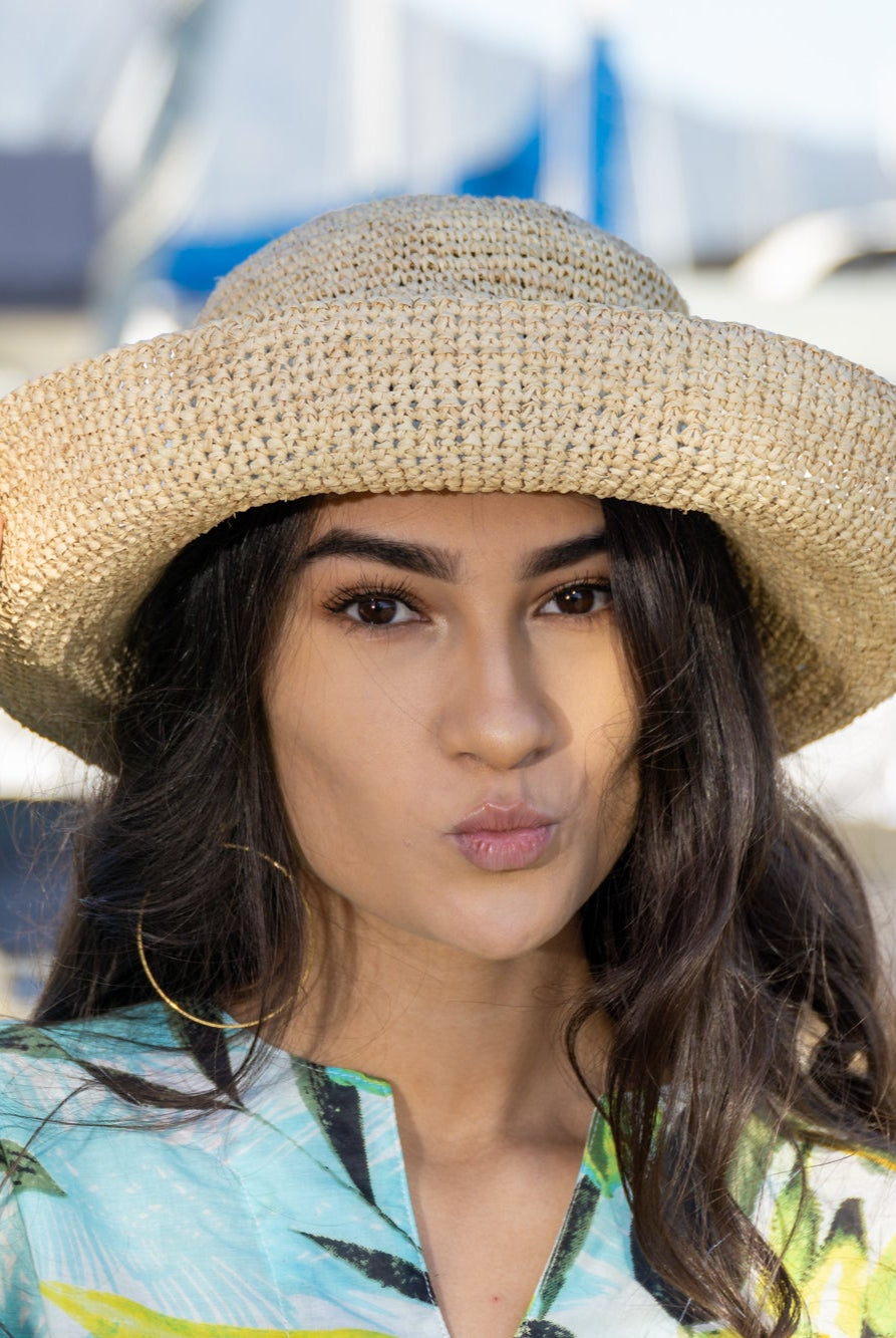 Model wearing 3 inch brim Leor natural crochet straw hat packable lightweight adjustable beach hat - Shebobo