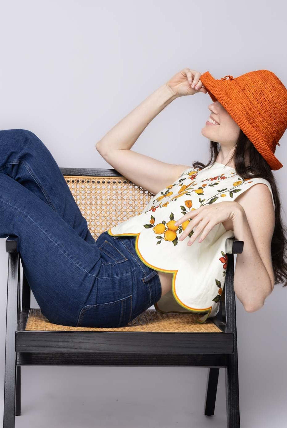 Model wearing Leor Sunkist crochet straw hat handmade woven natural raffia palm fiber in a solid hue of Sunkist ora raffia 3" brim packable straw hat with matching adjustable braided hat band - Shebobo