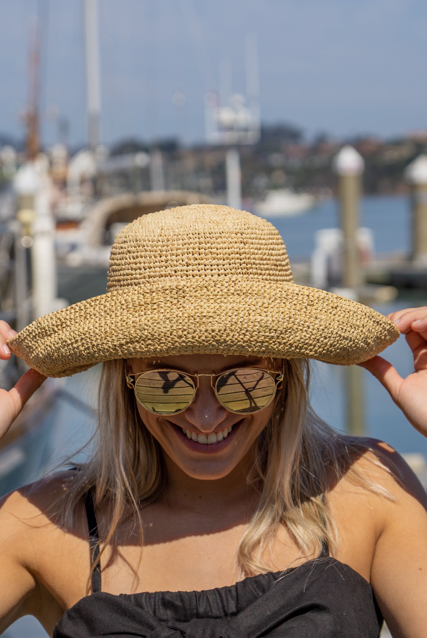 Model wearing Leor Natural crochet straw hat handmade natural straw color raffia 3" brim packable straw hat with matching adjustable braided hat band - Shebobo