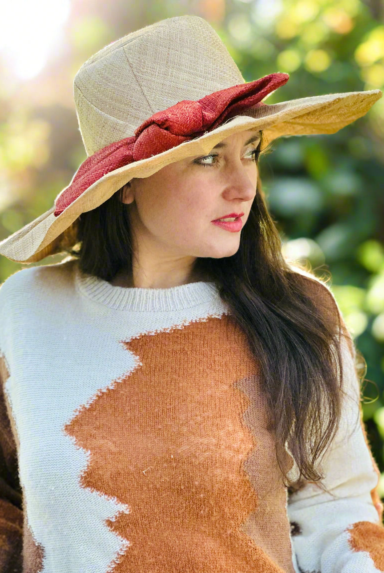Model wearing Lilly 5" Brim Fan Straw Sun Hat with Big Caramel red/brown bow and matching hatband on handmade natural loomed raffia pleated wide brim hat - Shebobo