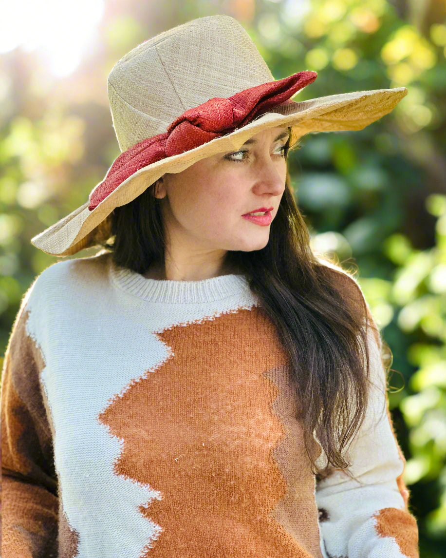 Model wearing Lilly 5" Brim Fan Straw Sun Hat with Big Caramel red/brown bow and matching hatband on handmade natural loomed raffia pleated wide brim hat - Shebobo