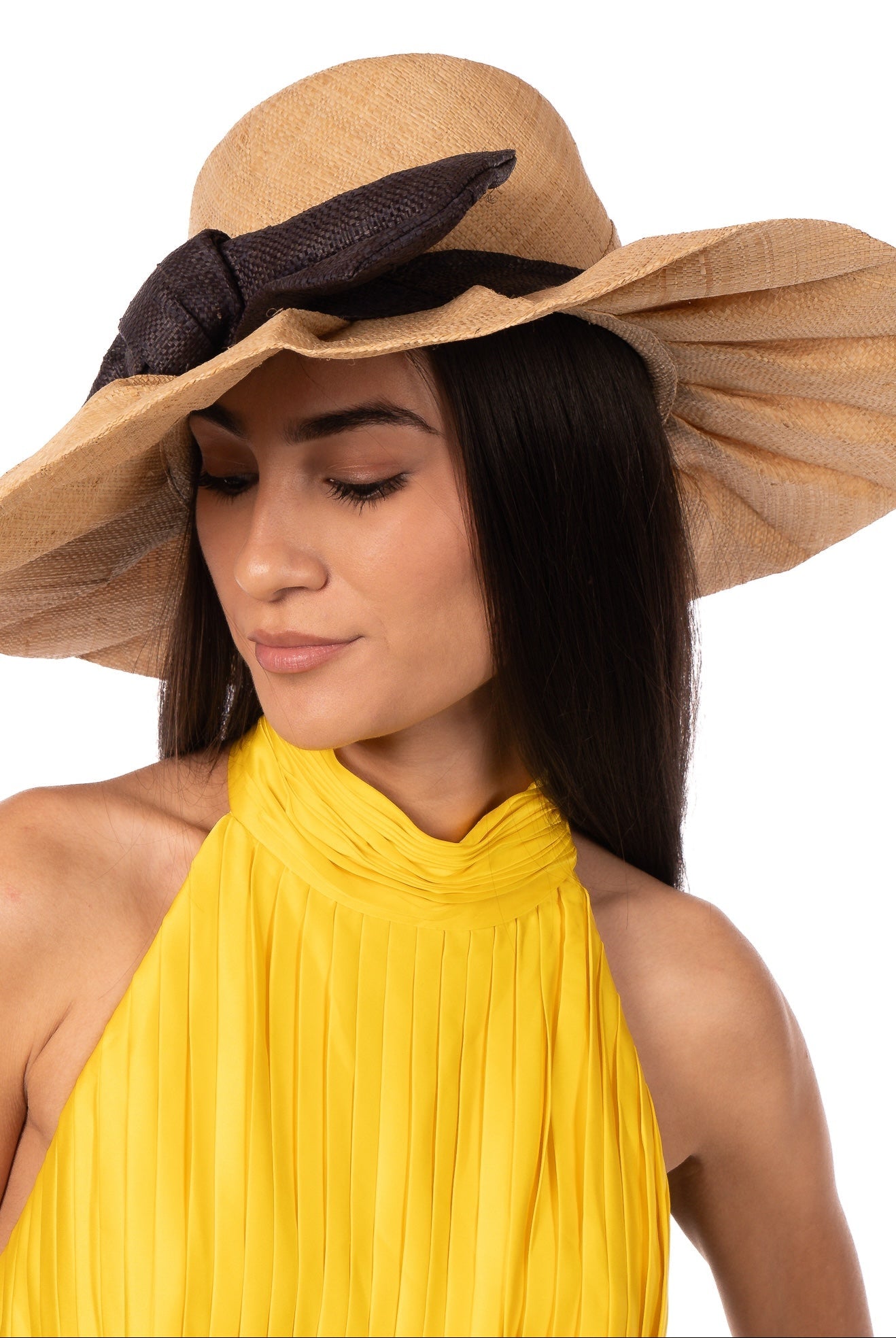 Model wearing Lilly 5" Brim Fan Straw Sun Hat with Big Black bow and matching hatband on handmade natural loomed raffia pleated wide brim hat - Shebobo