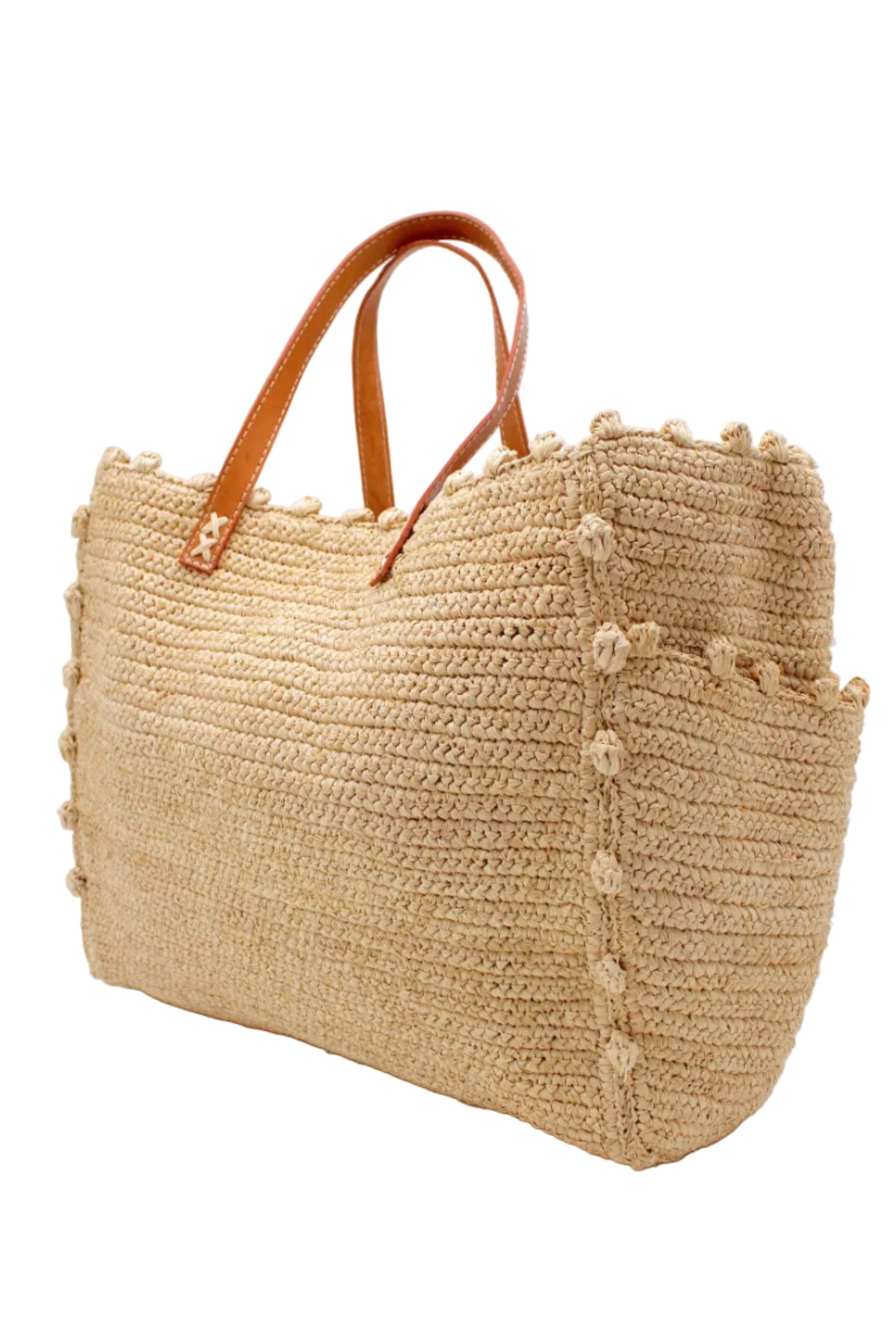 Side view Madeline Natural XL Crochet Raffia Straw Basket Shoulder Bag with Pockets handmade raffia palm fiber in a solid hue of natural straw color with crochet horizontal subtle band texture, round boucle nub edges, oversized external pockets, and leather handles - Shebobo