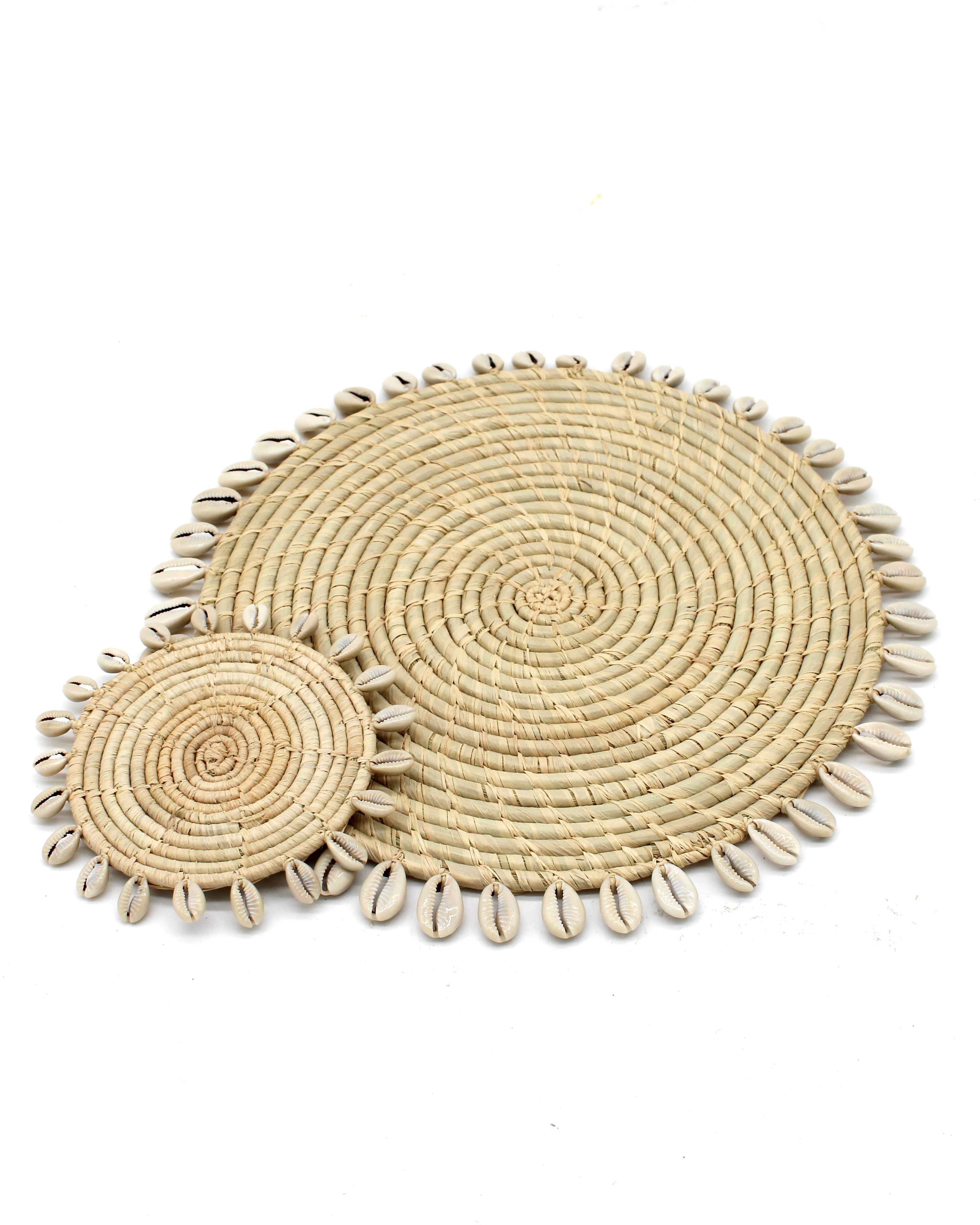 Detail view Makena Round Raffia Straw Coasters & Placemats with Cowrie Shell Edge Set of 6 handmade woven raffia palm fiber in a solid hue of natural straw color with coiled loop texture discs with cowrie shell edge embellishment set of six - Shebobo