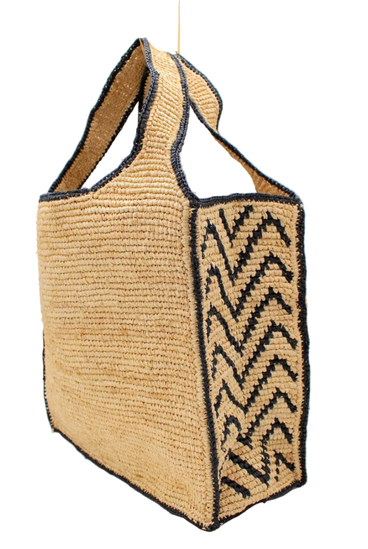 Side view Mamie Zigzag Pinstripe XL Crochet Straw Basket Handbag handmade crochet natural raffia palm fiber in a solid hue of natural straw color purse beach bag with contrasting black zigzag pinstripe pattern on the sides of the bag and matching outer edge - Shebobo