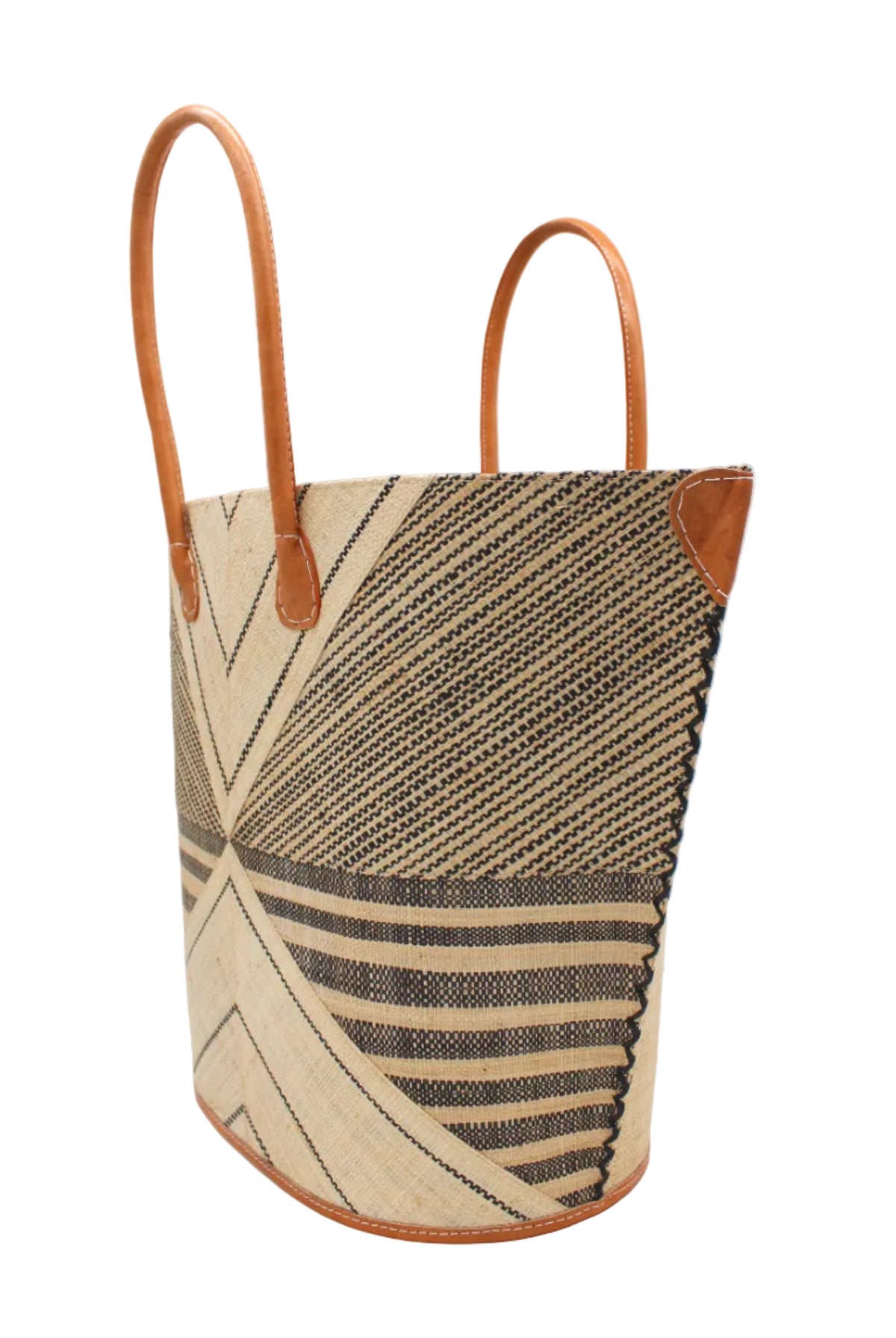 Side view Mariposa Large Straw Tote Bag handmade loomed natural raffia palm fiber in a multi paneled pattern design of pinstripe, melange, and wide stripe combinations geometrically radiating from the center point of the bag outwards in a two tone color combination of Natural straw color and black with a solid hue of color on the back of the bag plus leather handles and embellishments shoulder bag - Shebobo