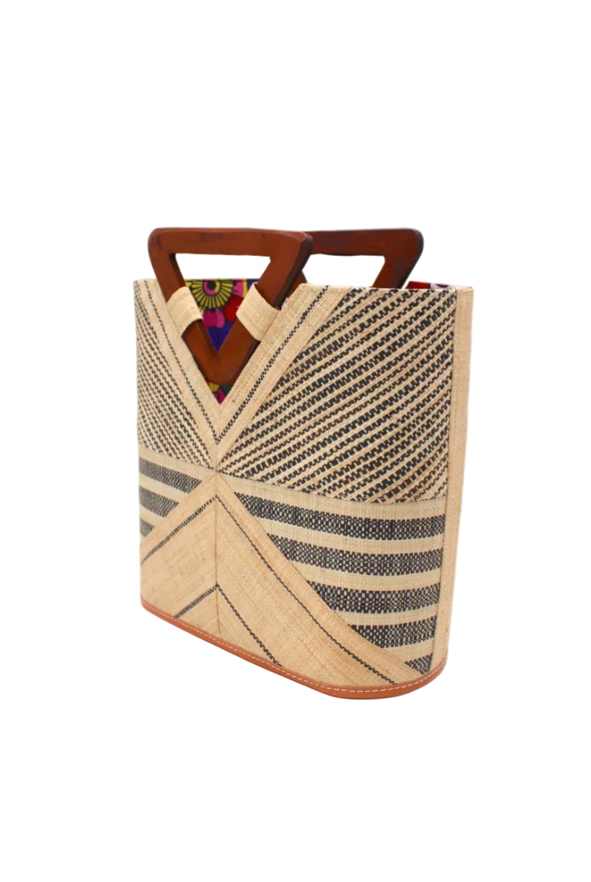 Side view Mariposa Zuki Raffia Straw Bucket Handbag with Wood Triangle Handles handmade loomed raffia palm fiber in a multi paneled pattern design of pinstripe, melange, and wide stripe combinations geometrically radiating from the center point of the bag outwards in a two tone color combination of Natural straw color and black with a solid hue of color on the back of the bag plus carved wooden handles purse - Shebobo