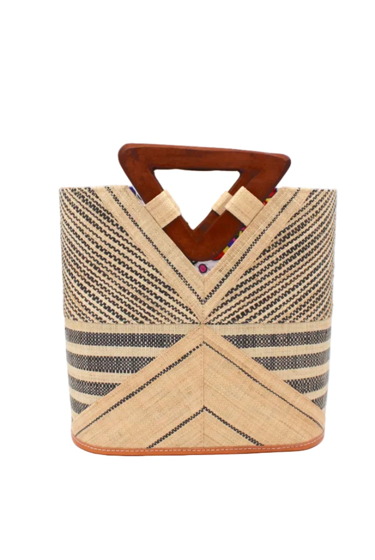 Mariposa Zuki Raffia Straw Bucket Handbag with Wood Triangle Handles handmade loomed raffia palm fiber in a multi paneled pattern design of pinstripe, melange, and wide stripe combinations geometrically radiating from the center point of the bag outwards in a two tone color combination of Natural straw color and black with a solid hue of color on the back of the bag plus carved wooden handles purse - Shebobo