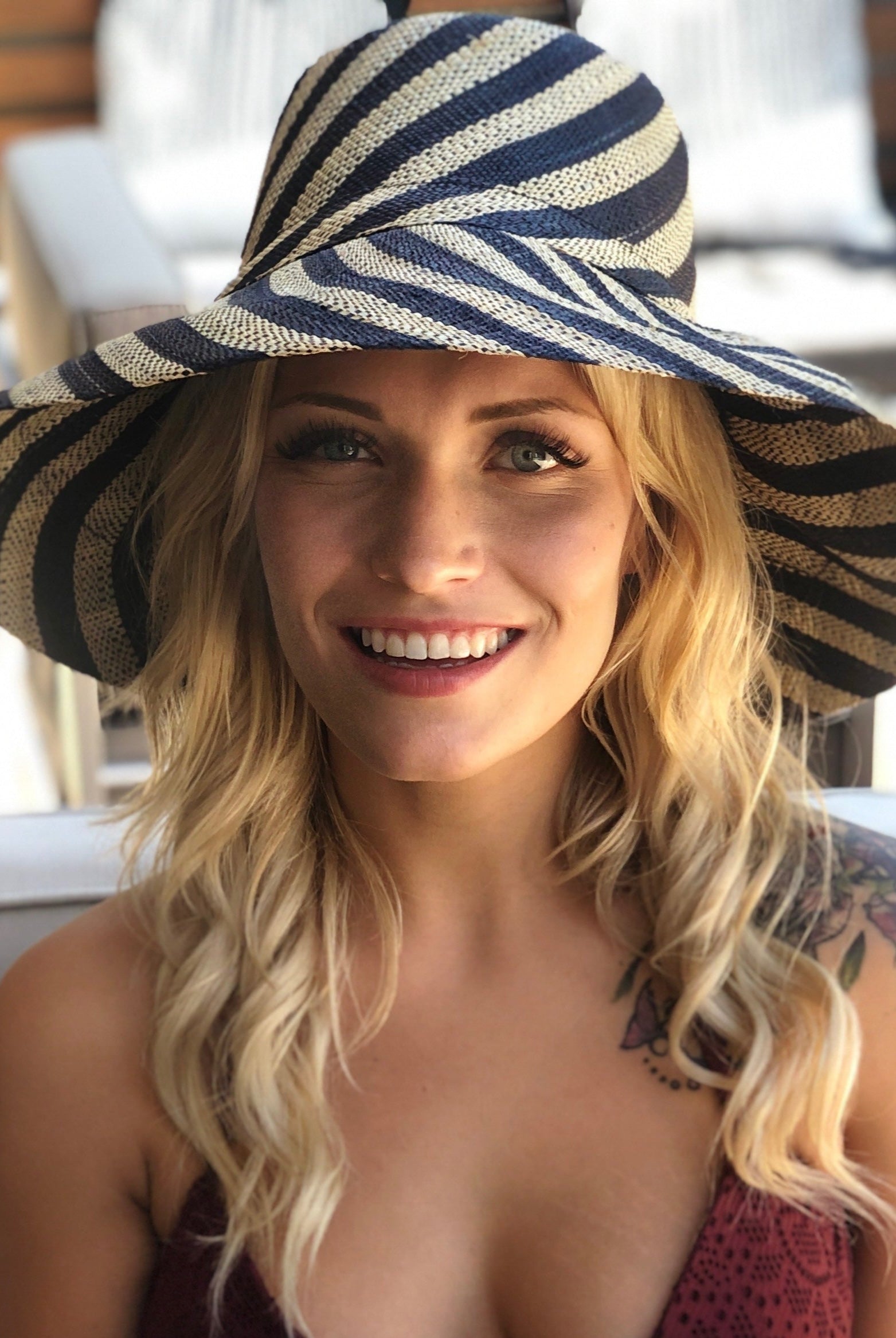 Model wearing Monica 5" Wide Brim Black and Natural Stripe Multicolor Stripe Pattern Packable Straw Sun Hat handmade loomed raffia in bands of black and natural straw color create a striped swirl pattern - Shebobo