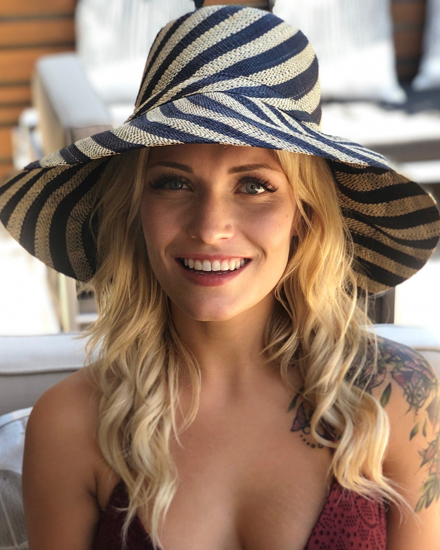 Model wearing Monica 5" Wide Brim Black and Natural Stripe Multicolor Stripe Pattern Packable Straw Sun Hat handmade loomed raffia in bands of black and natural straw color create a striped swirl pattern - Shebobo