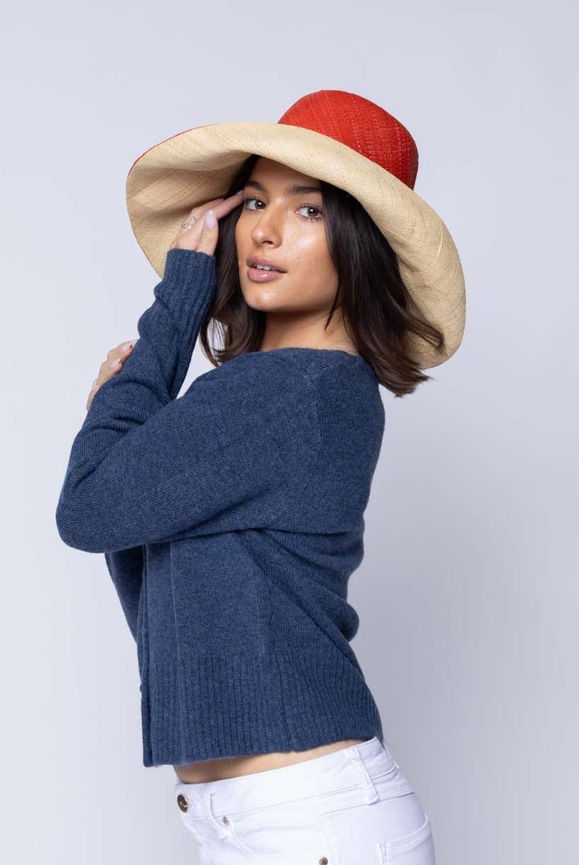 Model wearing Monica 5" & 7" Brim Two Tone Coral red/orange Straw Hat handmade loomed raffia color block pattern of the top half coral orange/red and the bottom half natural straw color - Shebobo