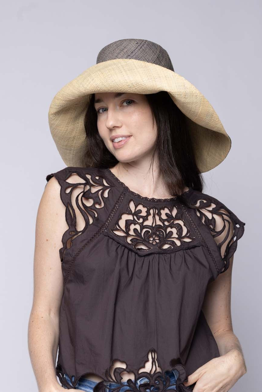 Model wearing Monica 5" & 7" Wide Brim Two Tone Grey Packable Straw Sun Hat handmade loomed raffia in a color block of the top half of the hat in grey and the bottom half natural straw color - Shebobo