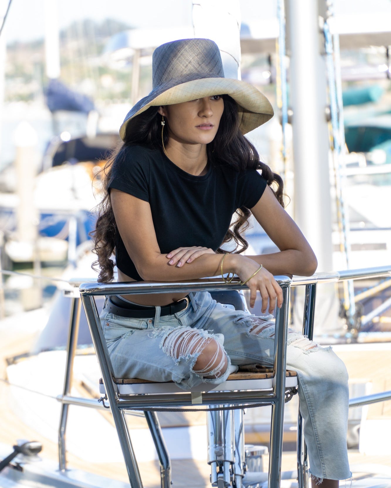 Model wearing Monica 5" wide brim two tone grey and natural packable raffia straw hat handmade loomed raffia top half grey, bottom half natural - Shebobo