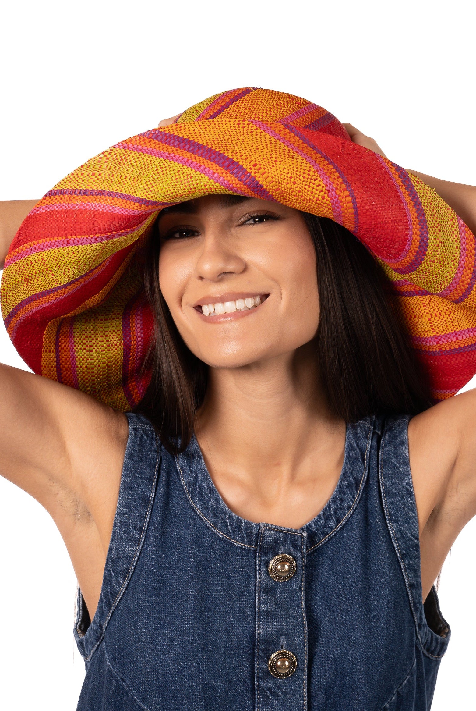 Model wearing Monica 7" Wide Brim Orange & Lime Swirl Multicolor Stripes Packable Straw Sun Hat Handmade loomed raffia in multi width bands of saffron yellow, pink, orange, purple, etc. create a swirl pattern - Shebobo