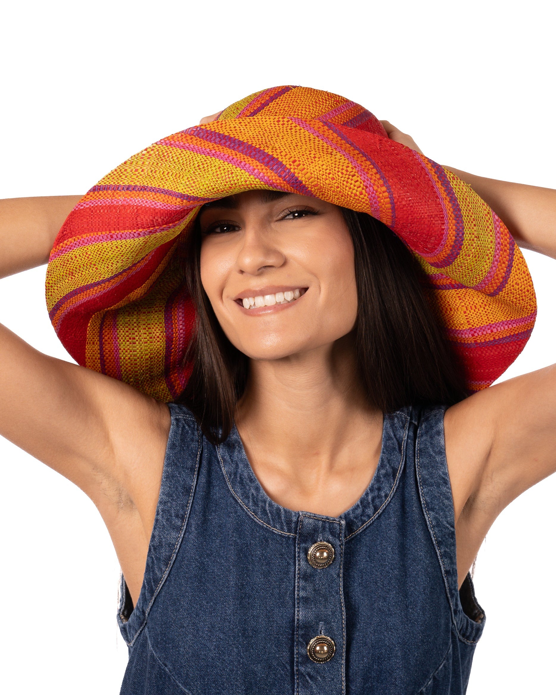 Model wearing Monica 7" Wide Brim Orange & Lime Swirl Multicolor Stripes Packable Straw Sun Hat Handmade loomed raffia in multi width bands of saffron yellow, pink, orange, purple, etc. create a swirl pattern - Shebobo