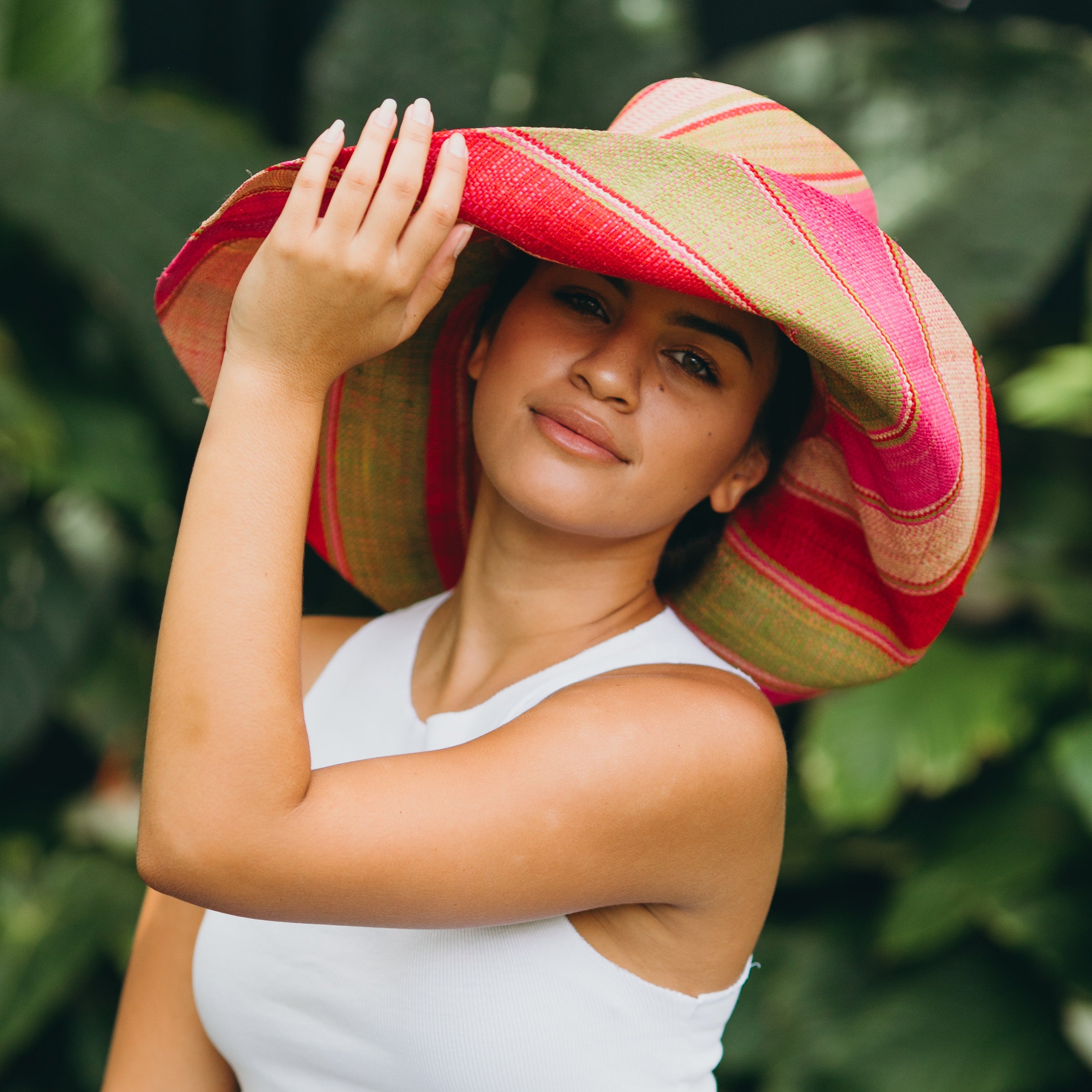 Model wearing Monica 7" Wide Brim Pink & Midori Swirl Multicolor Stripes Packable Straw Sun Hat Handmade loomed raffia in multi width bands of fuchsia pink, red, light pink, midori lime/green, and natural straw color create a swirl pattern - Shebobo